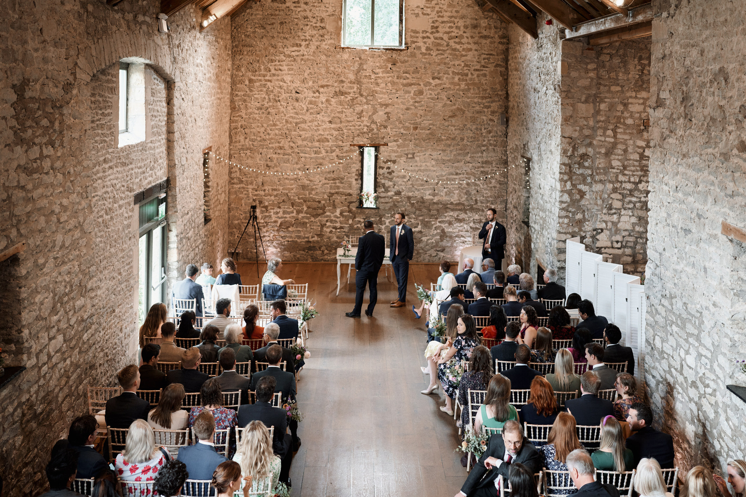 A wedding is taking place in a barn made of stone.