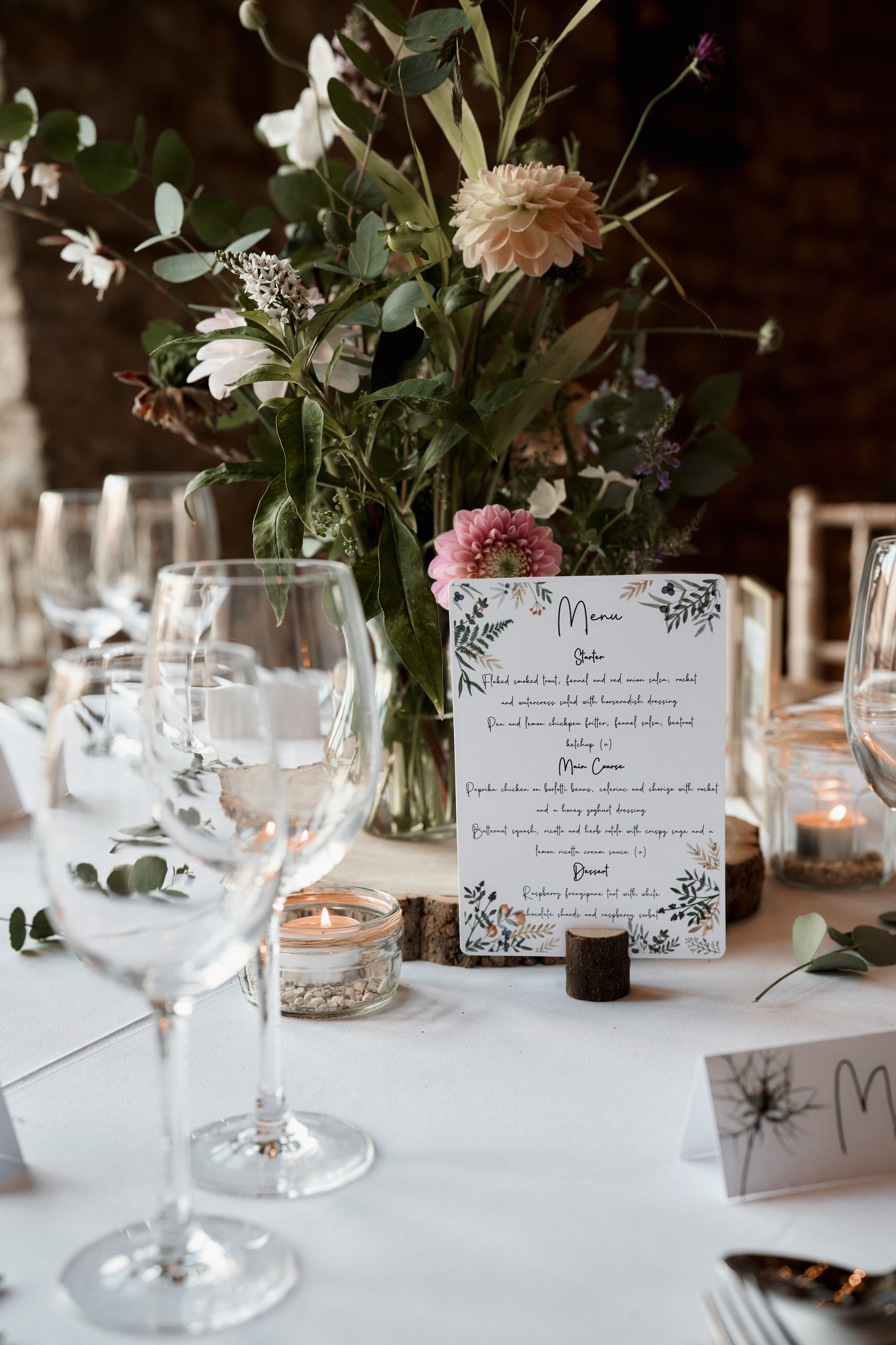 A table set-up with flowers and a name card.