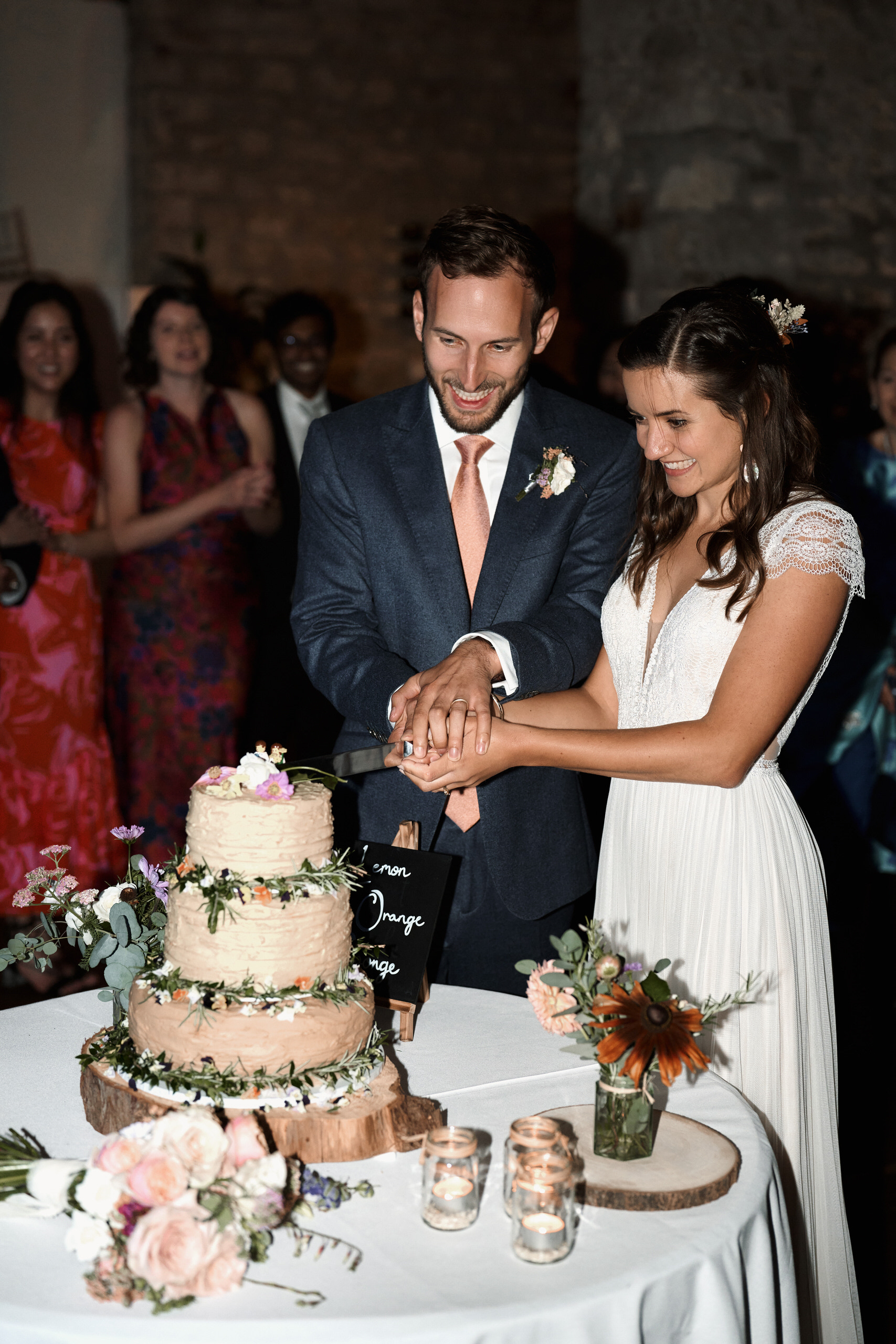 A couple slicing their wedding cake.