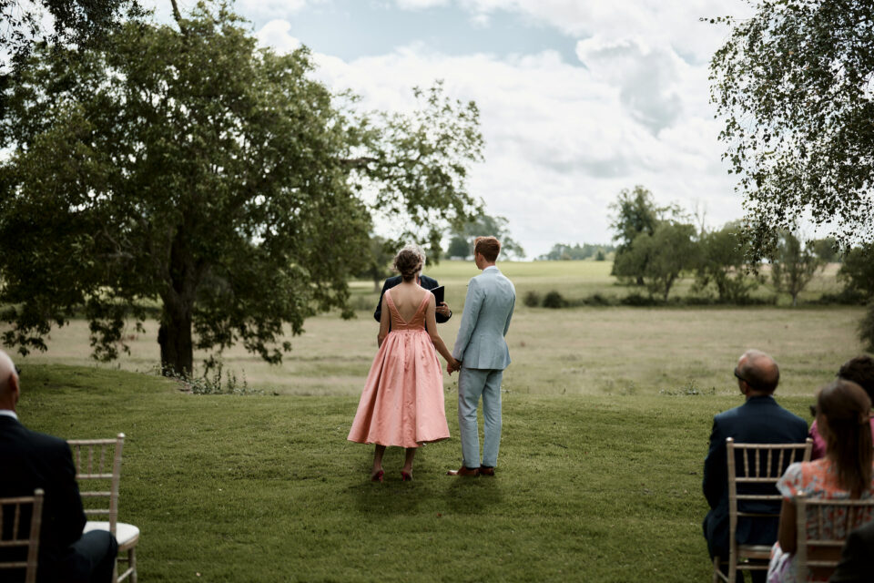 A couple getting married in a field.