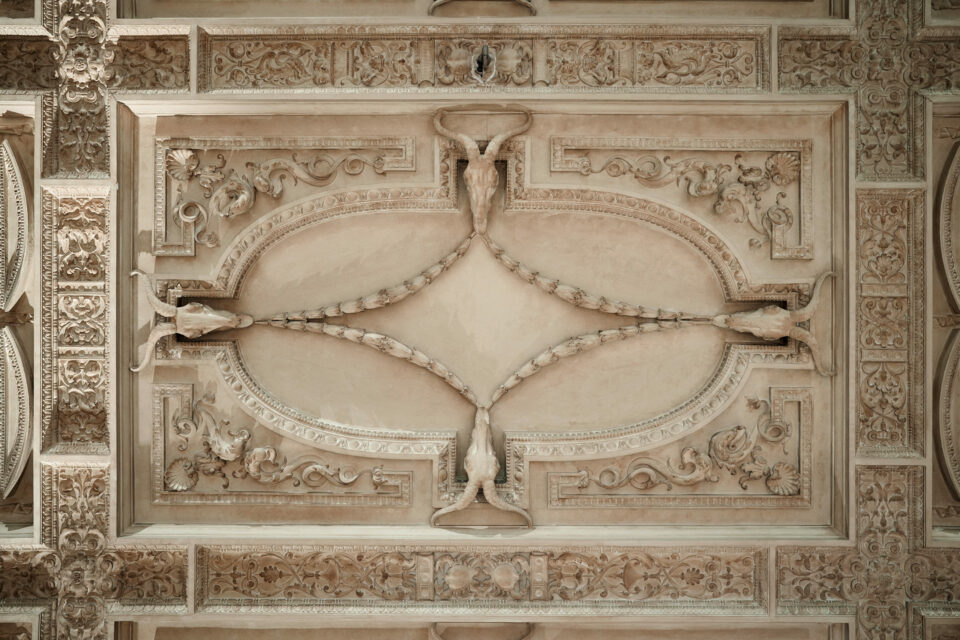 A fancy, decorated ceiling in a building.