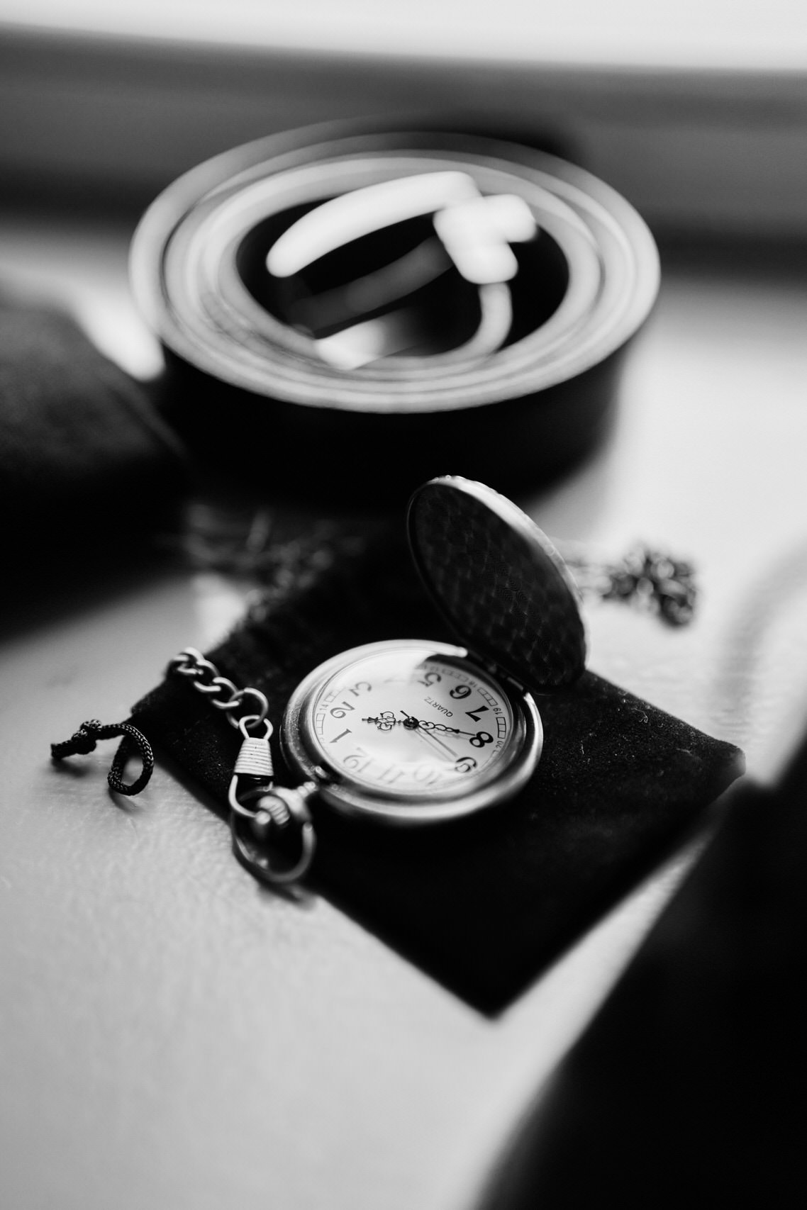 A picture of a pocket watch in black and white.