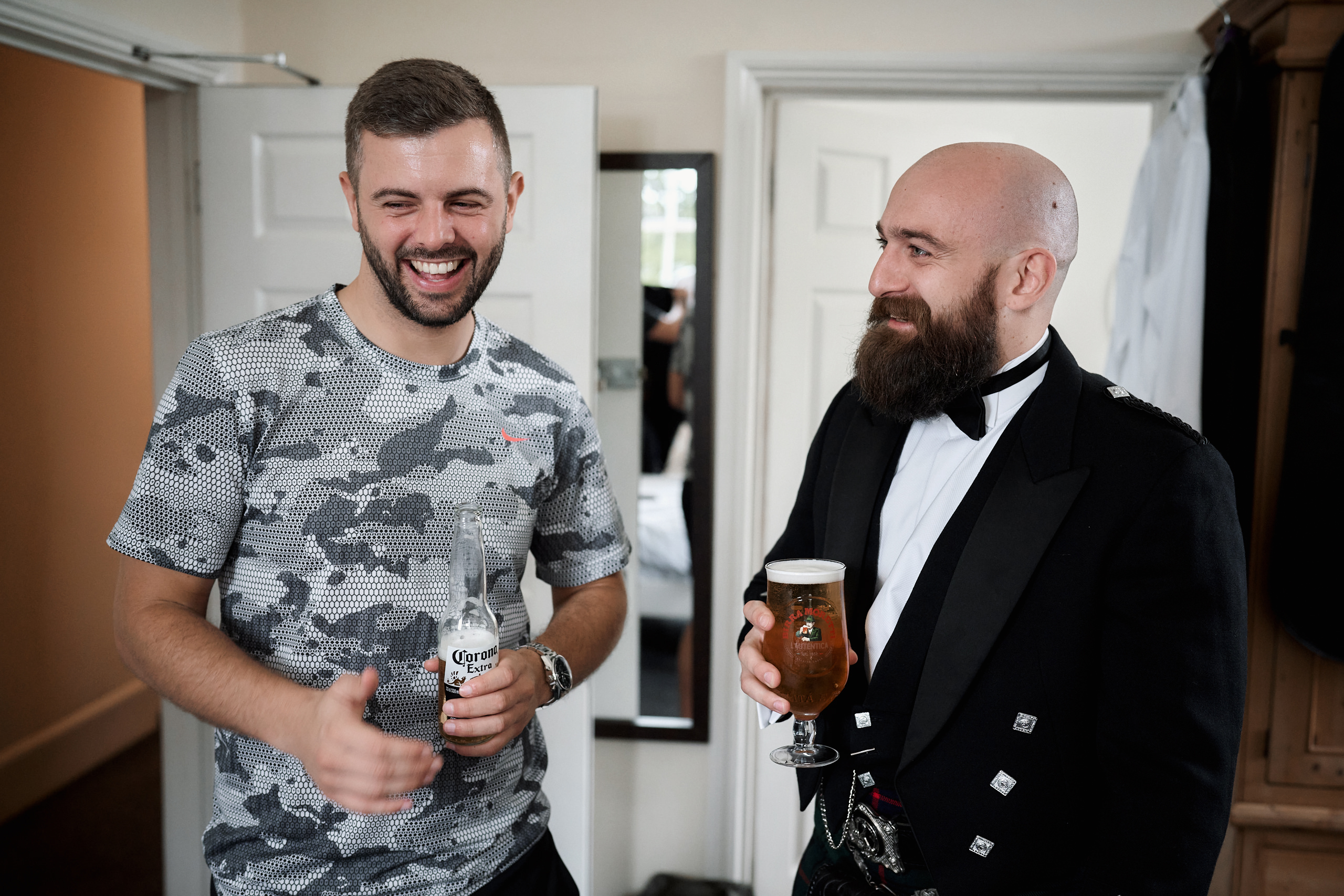 A man in a tuxedo and a man in a kilt.