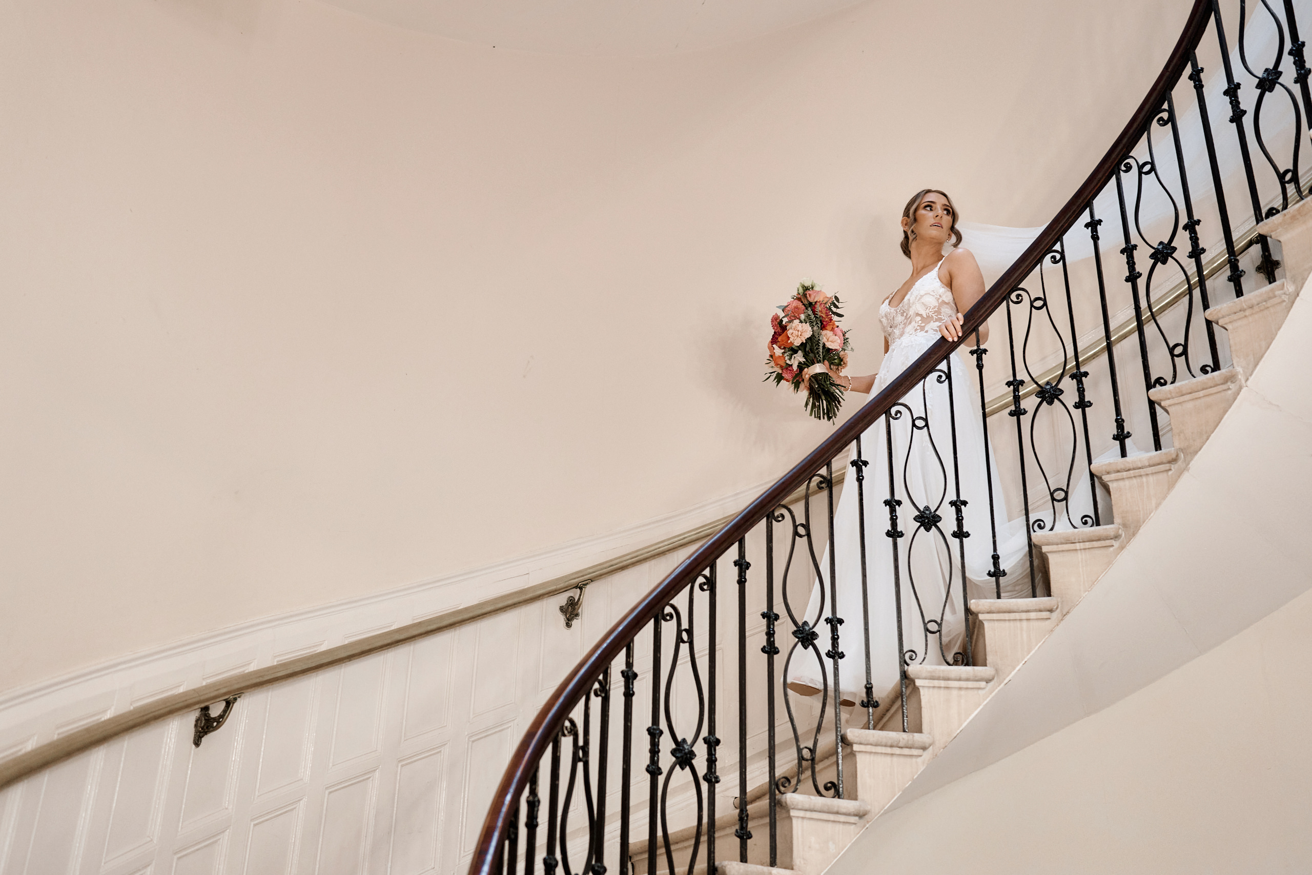 A bride standing on the stairs of a building.