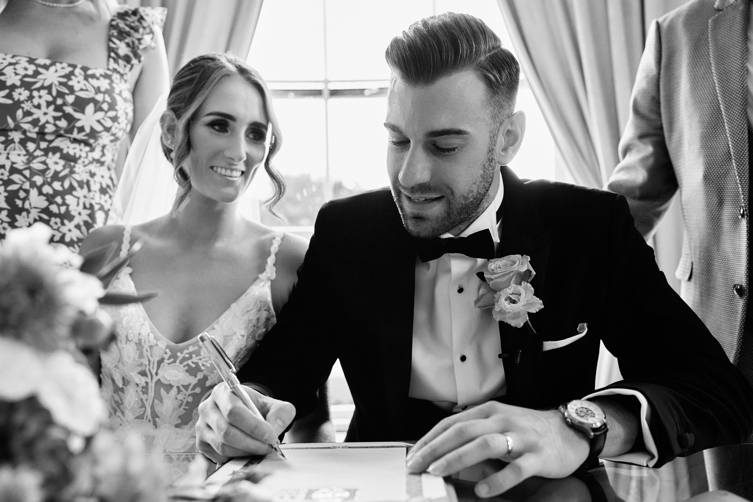 A bride and groom signing their wedding vows.