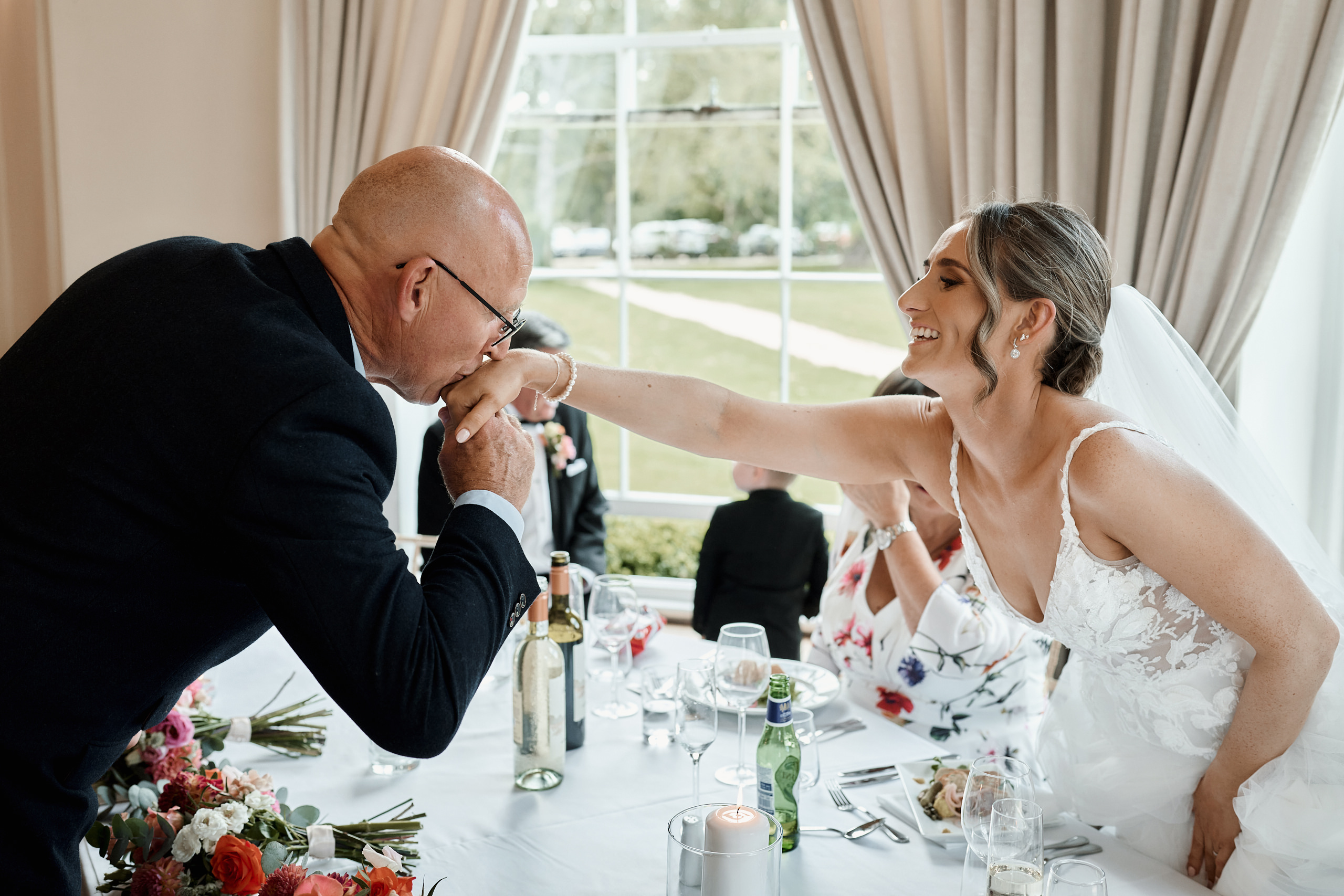 A bride and groom feeding each other at a wedding reception.