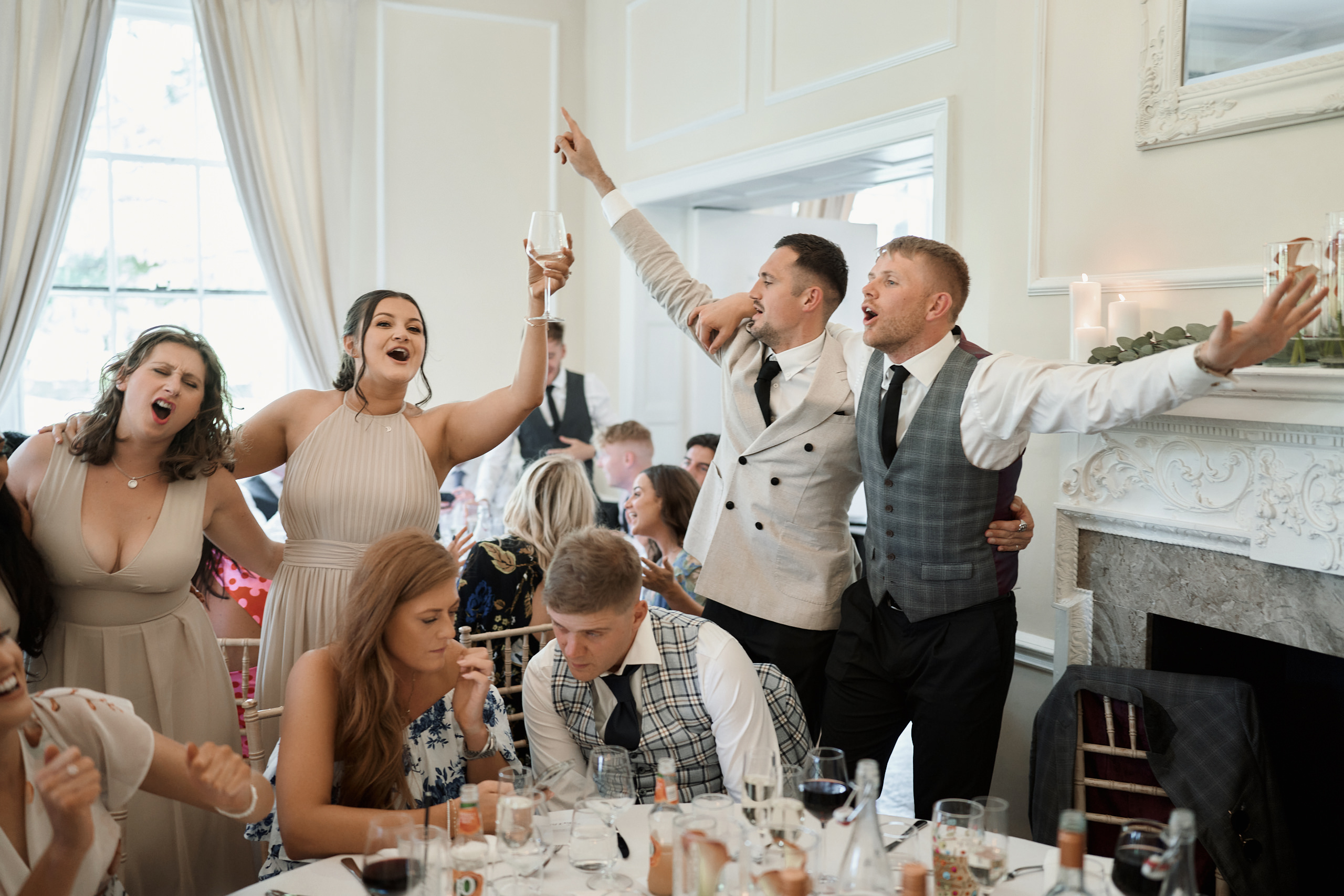 A group of people celebrating at a wedding reception.