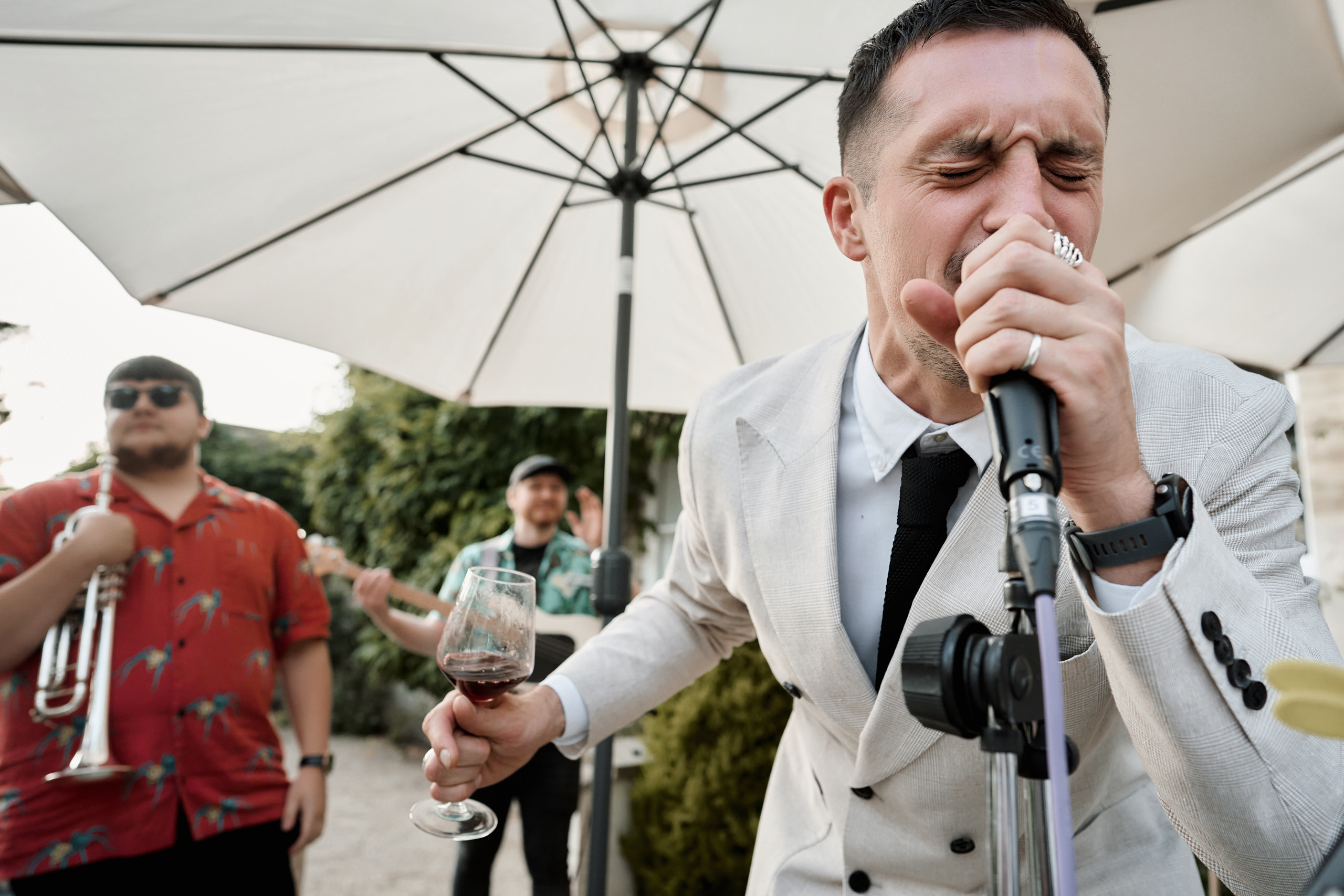 A man in a suit singing into a microphone.