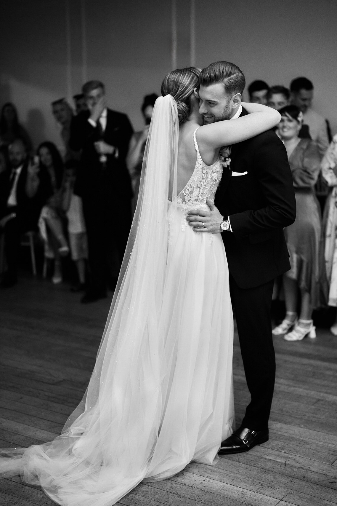 A bride and groom embrace during their first dance.