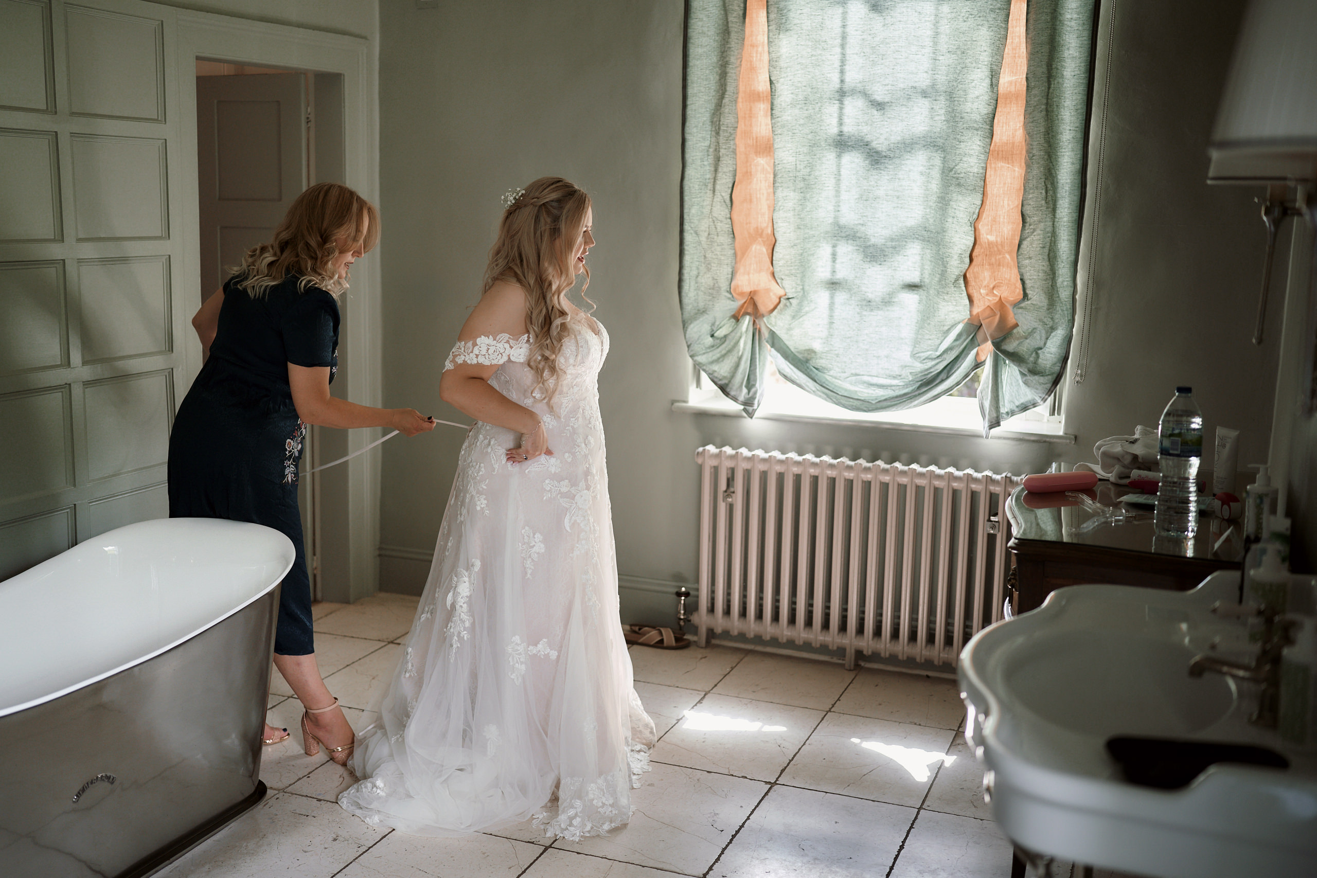 A bride is preparing herself in the bathroom.