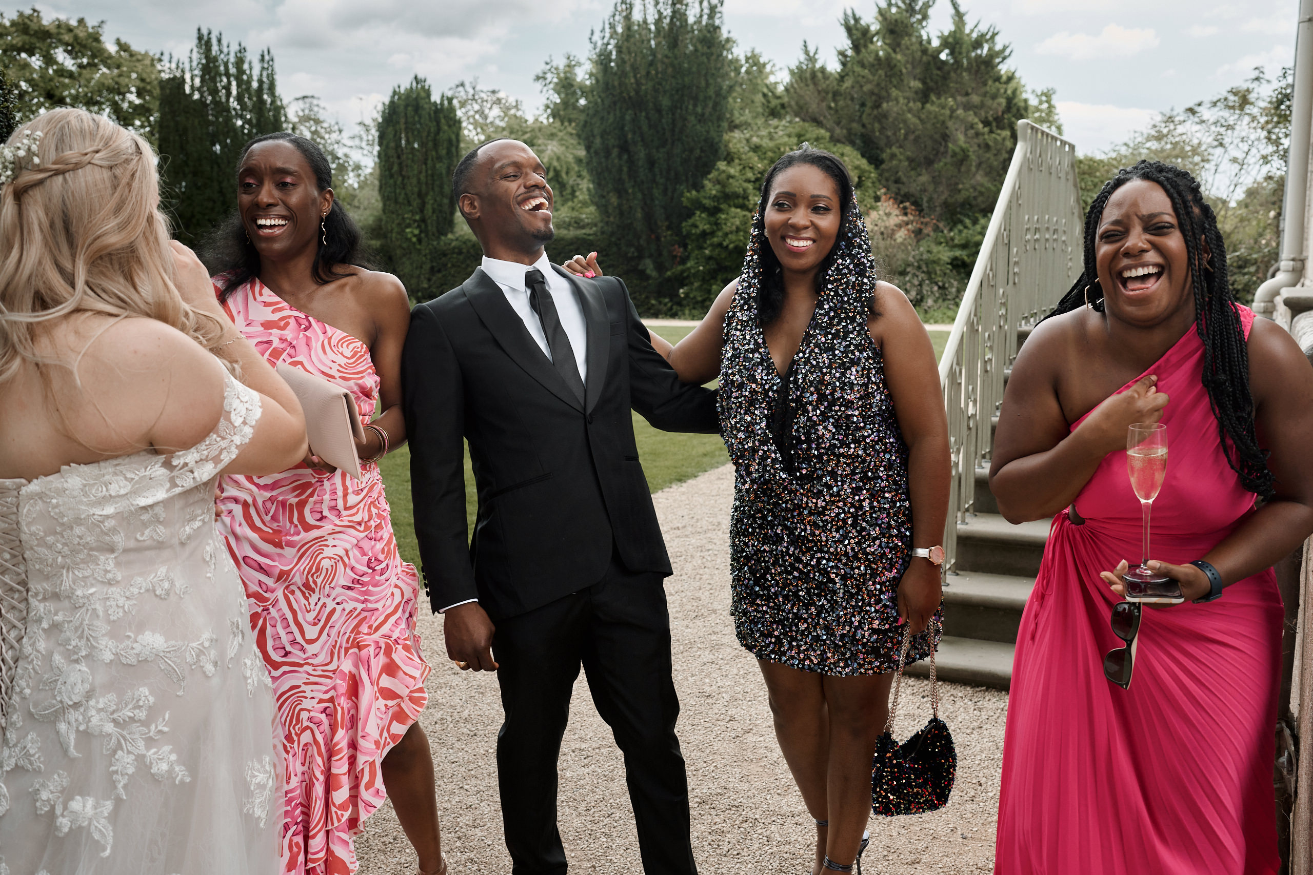 Some folks cracking up at a wedding.