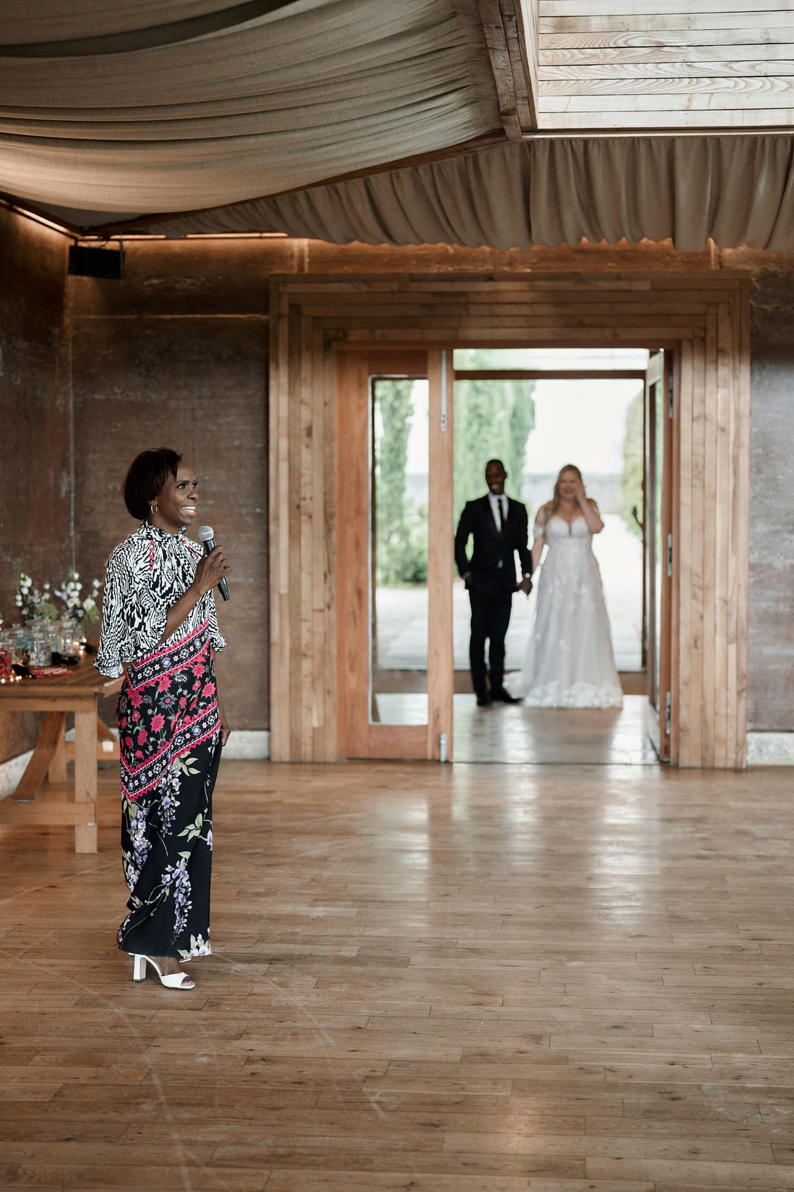 A couple getting married is standing in a room made of wood.