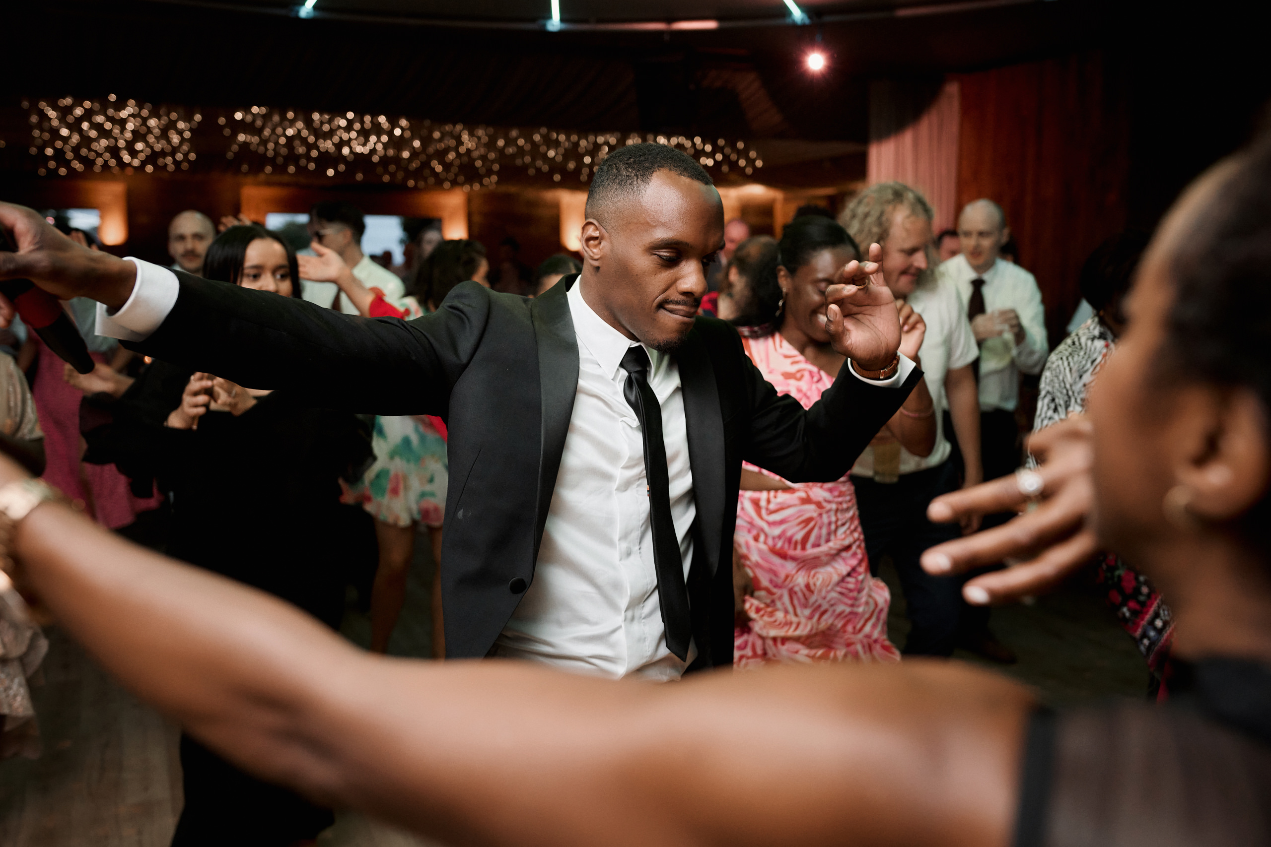 A guy and a girl are dancing at a wedding party.