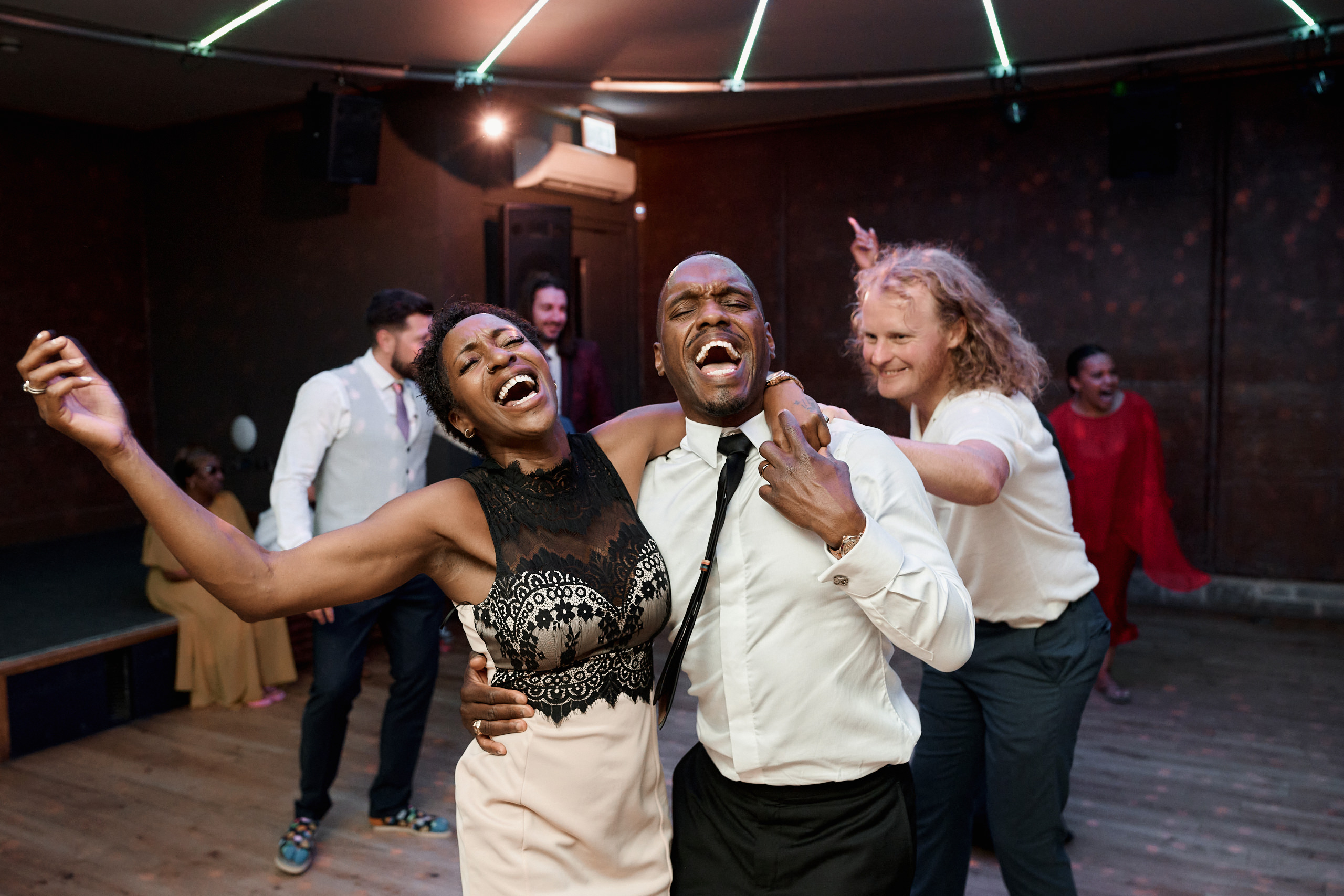 A pair is busting a move on the dance floor at a wedding party.