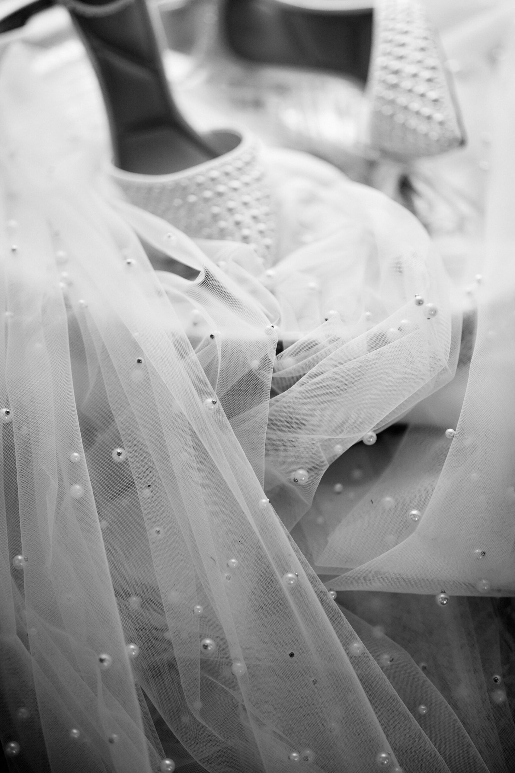 A picture of a wedding dress and shoes in black and white.