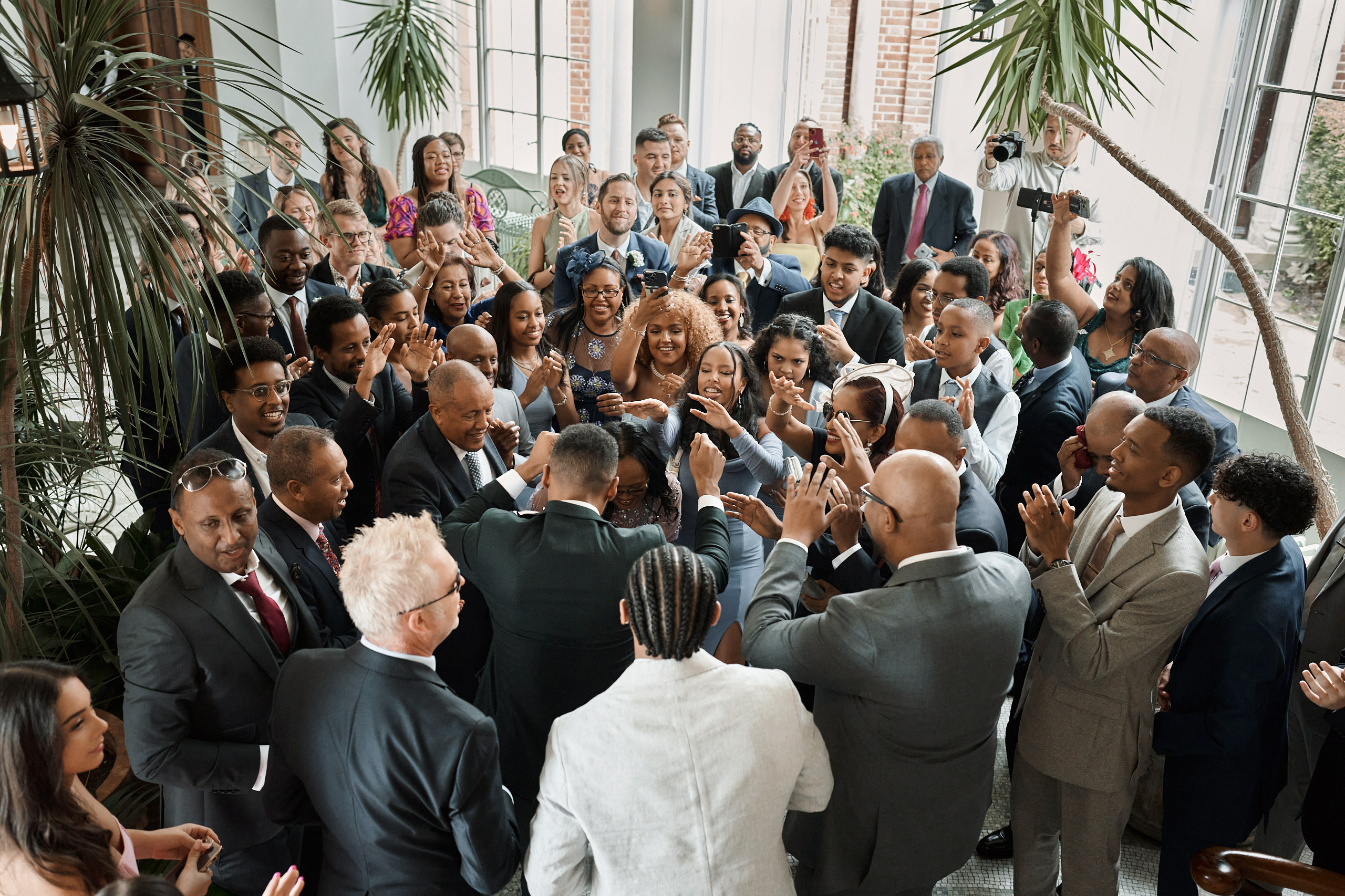 People clapping at a wedding party.