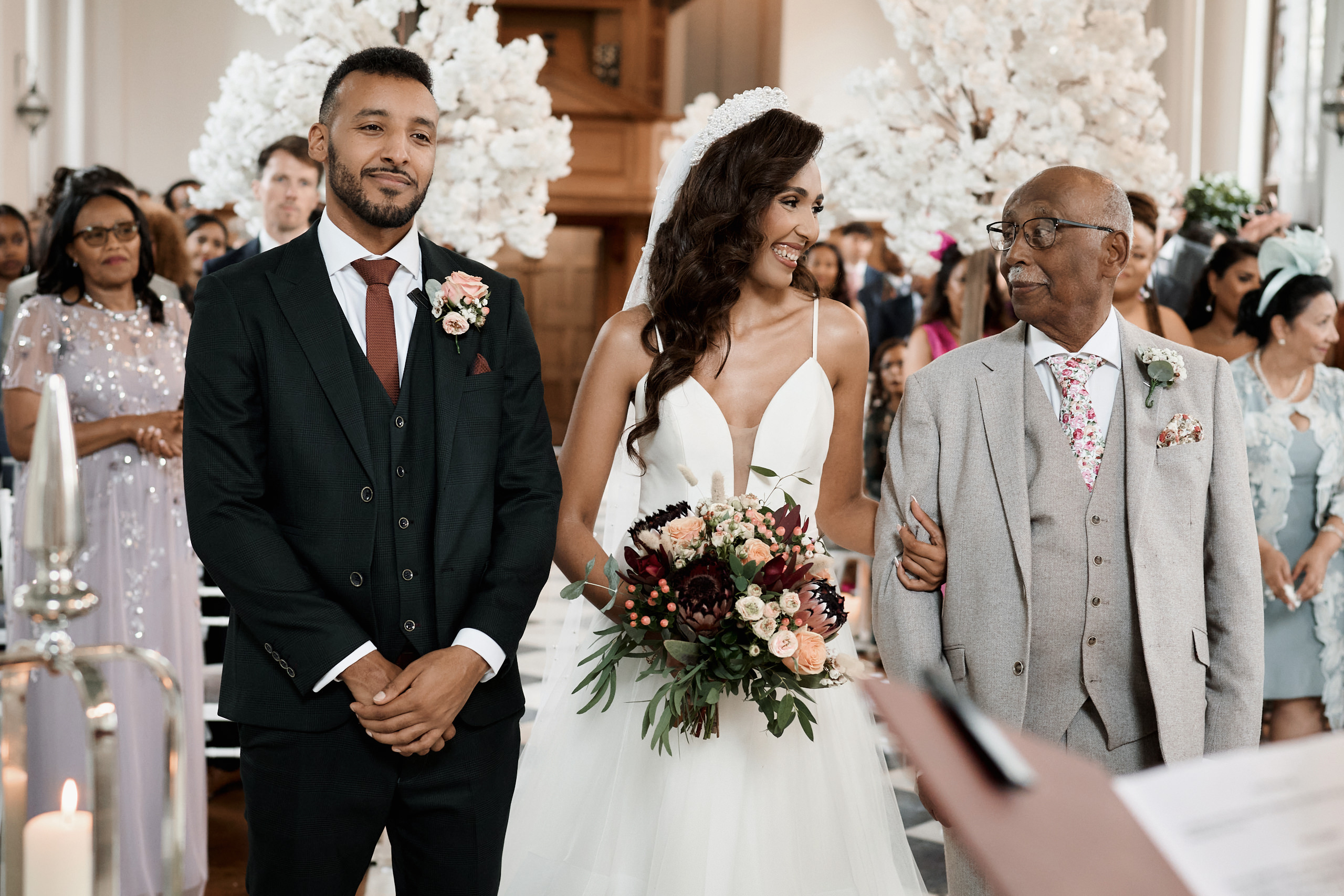 A woman is going down the aisle with her dad at her wedding.
