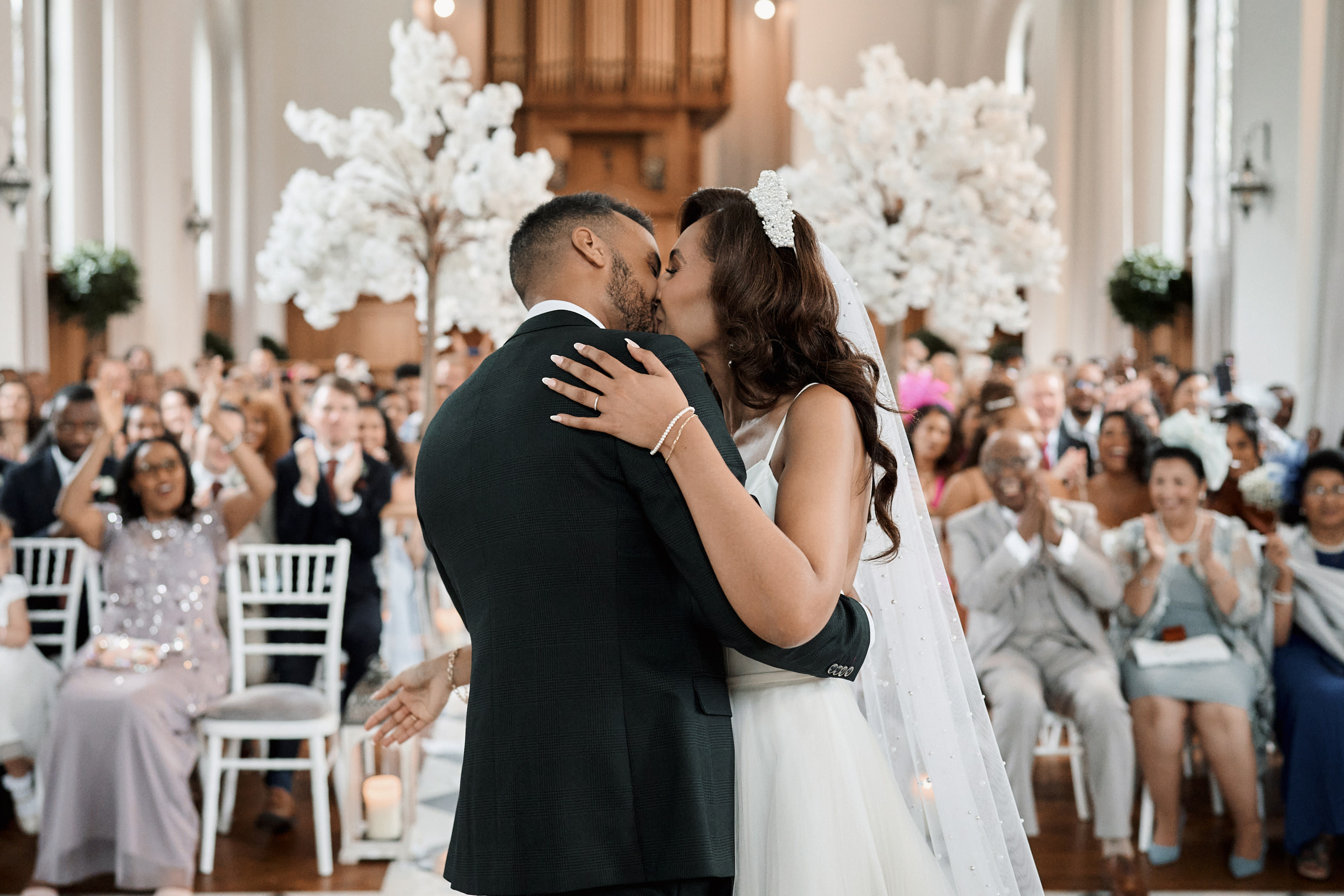 A couple kisses during their wedding.