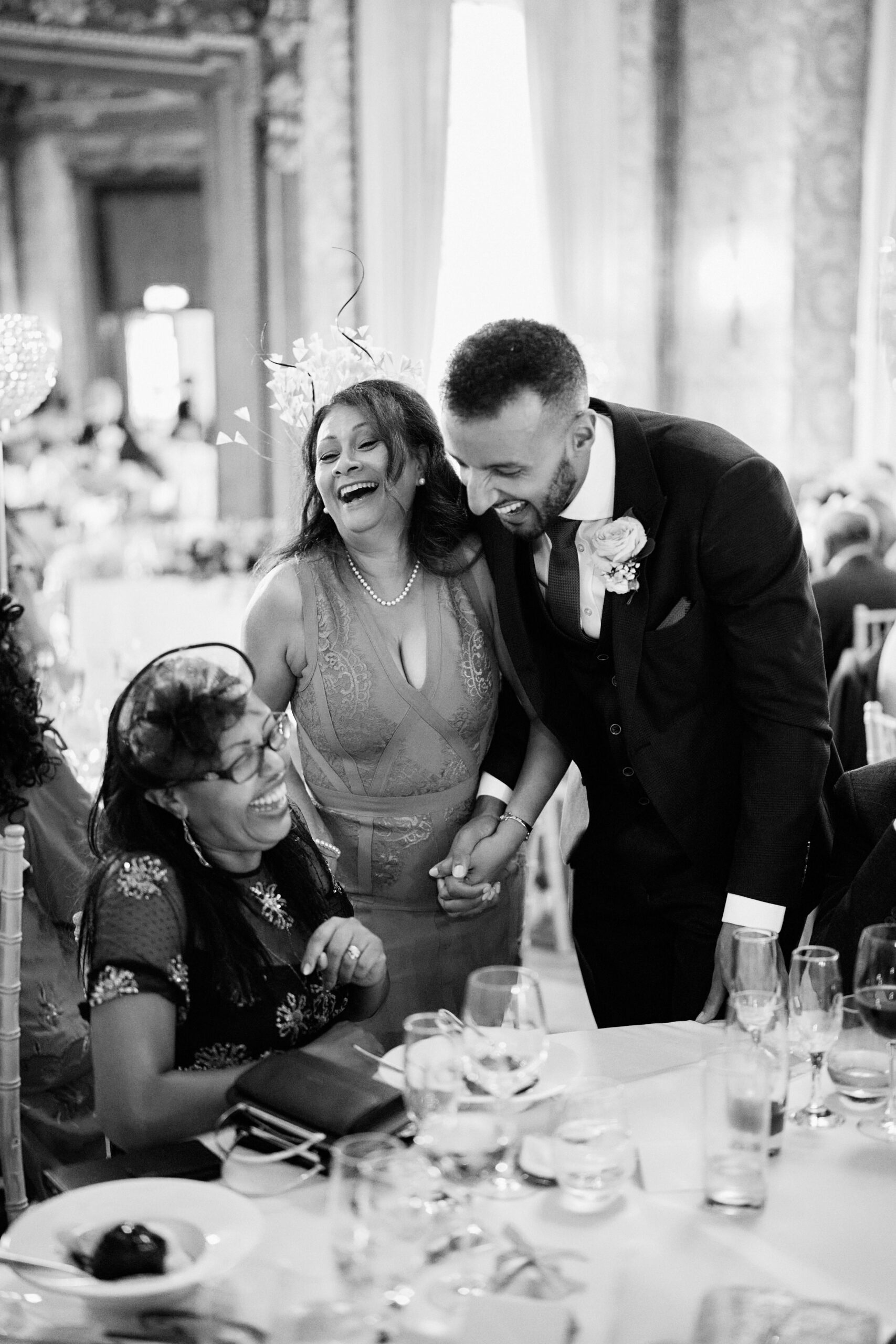A black and white picture of some folks at a wedding.