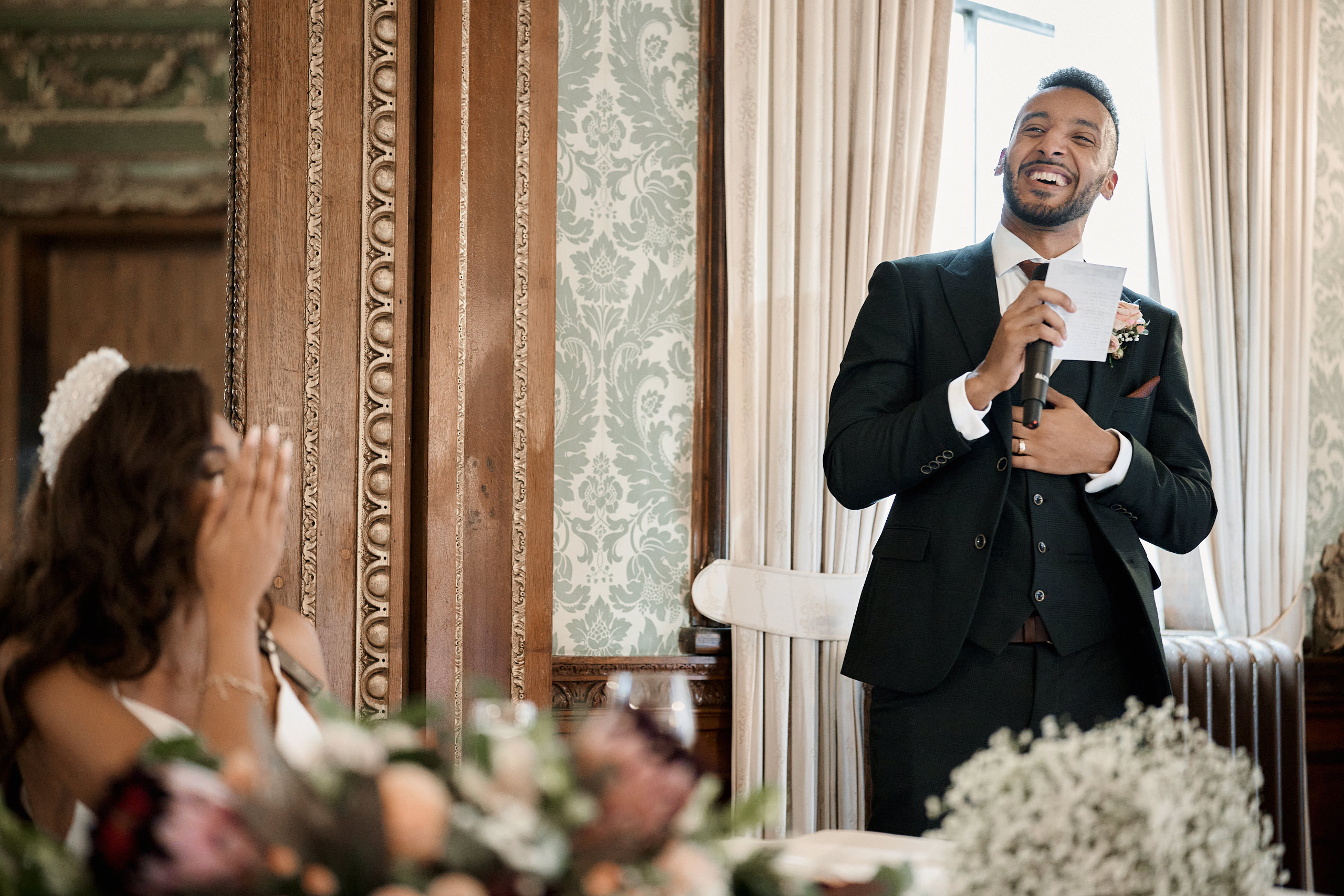 A man giving a talk at a wedding.