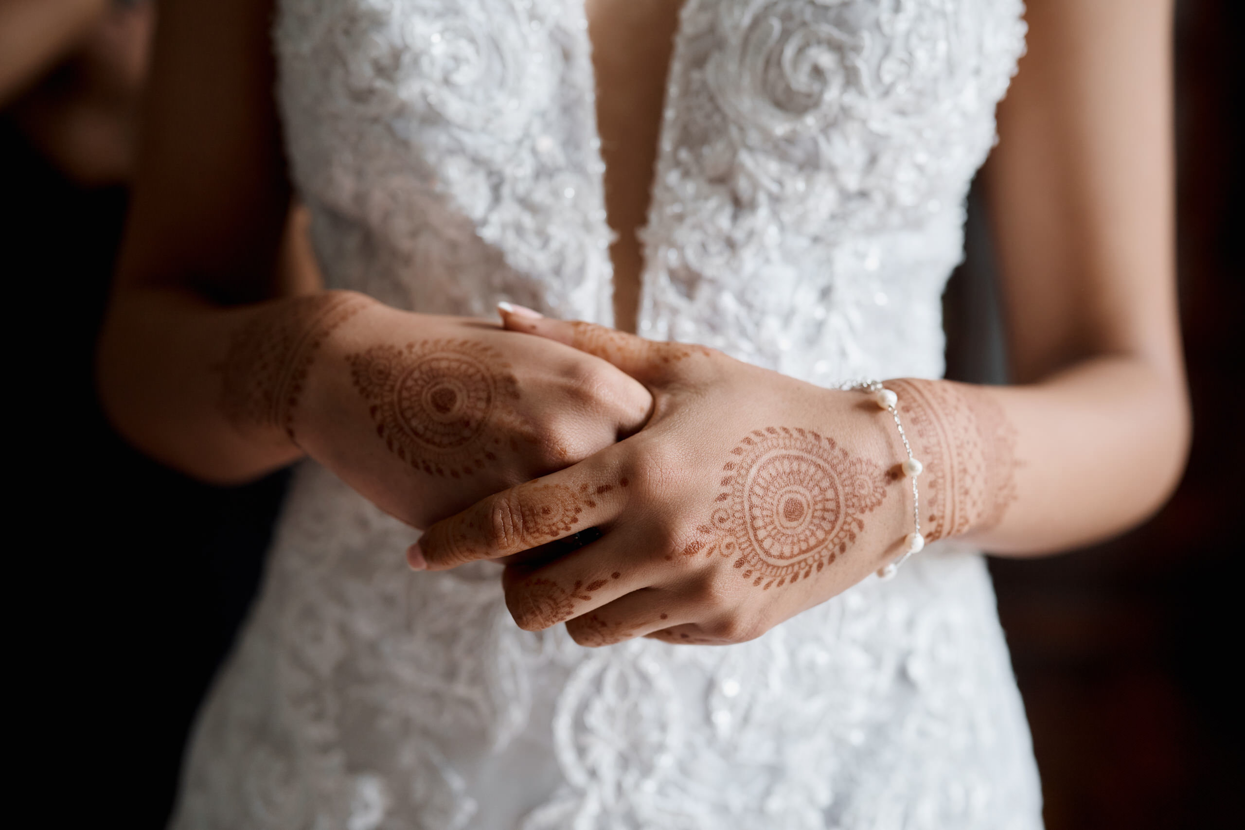 A bride has henna designs on her hands.
