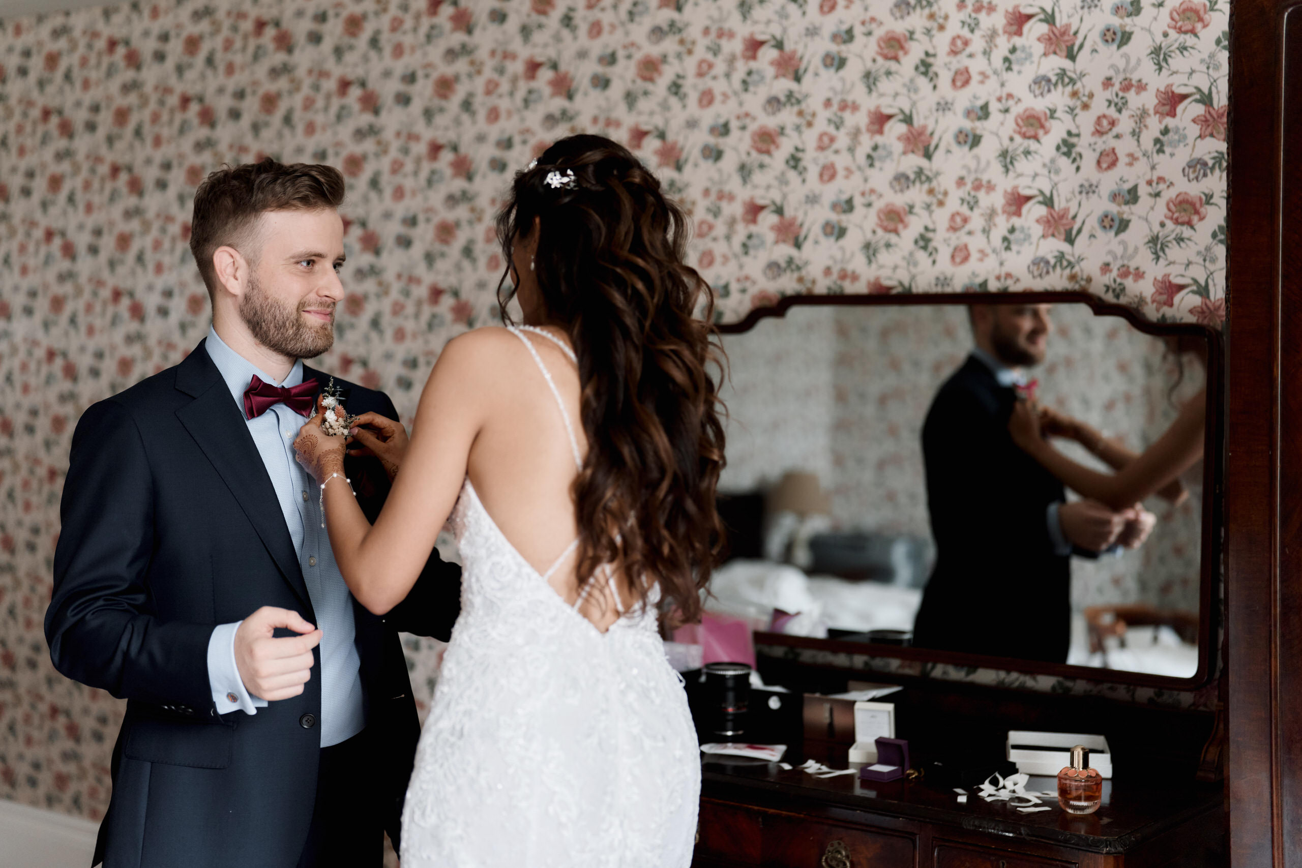 A bride and groom are preparing for their wedding.