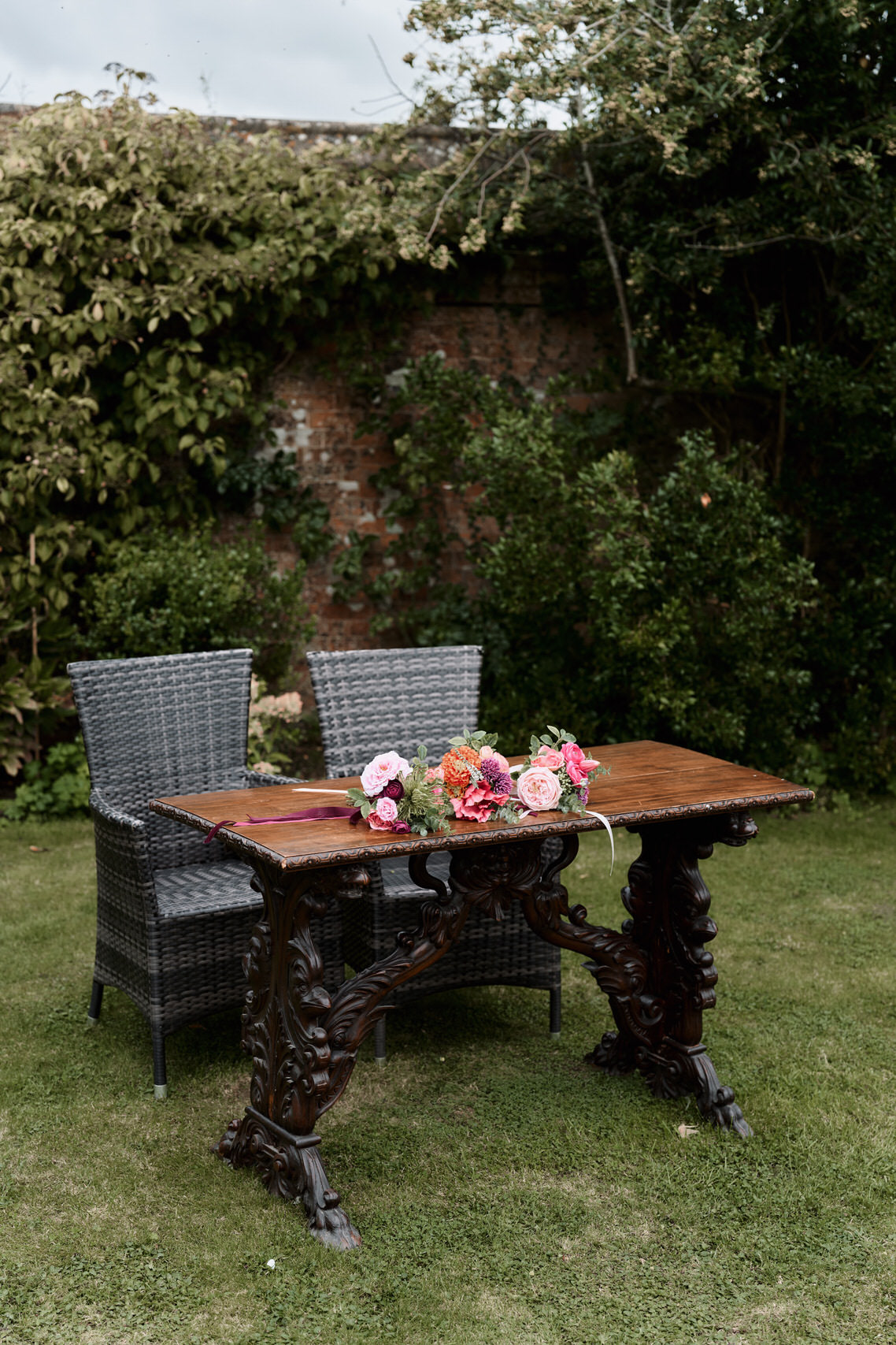 A garden table made of wood with chairs that are woven.