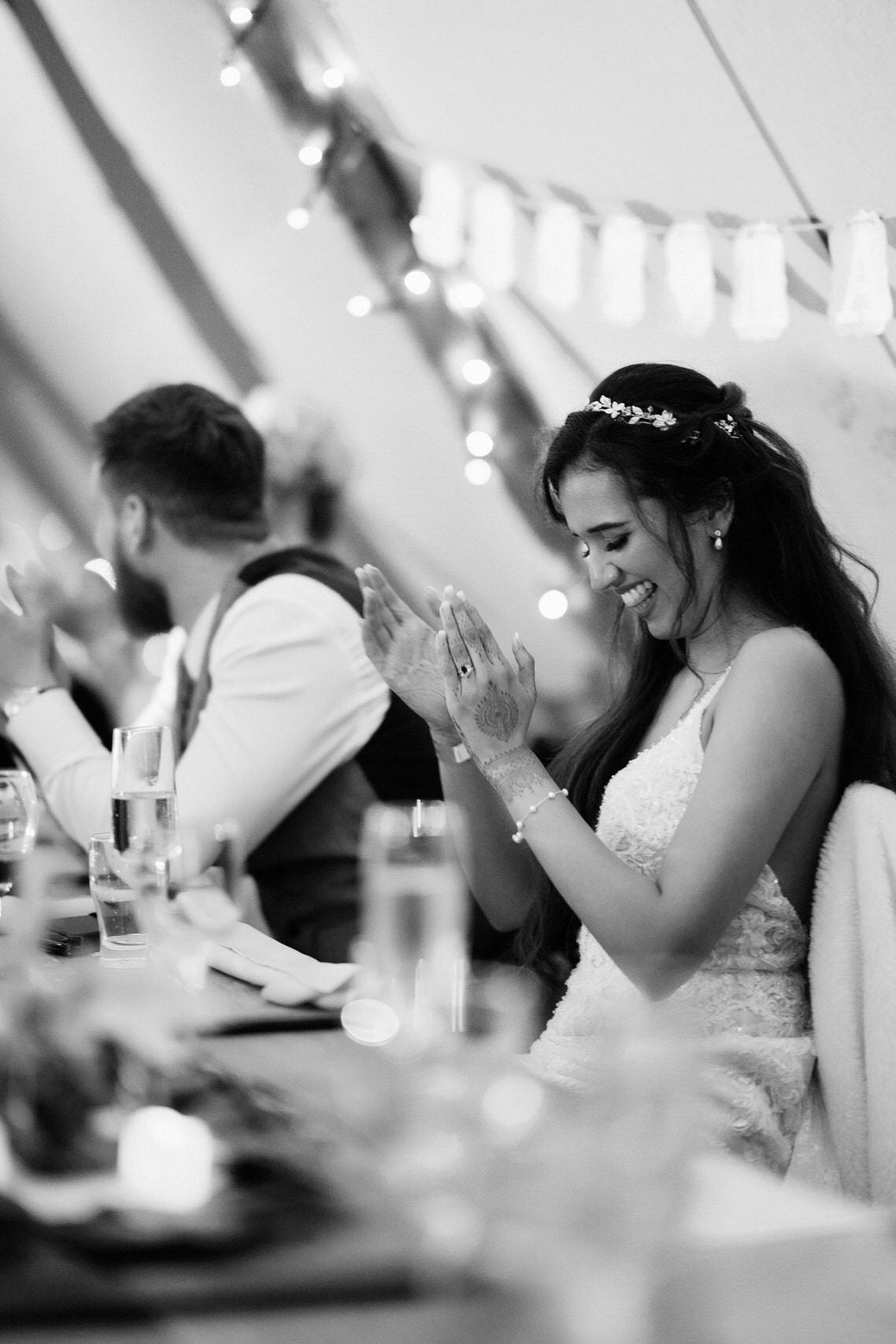 A couple applauding at their wedding party.