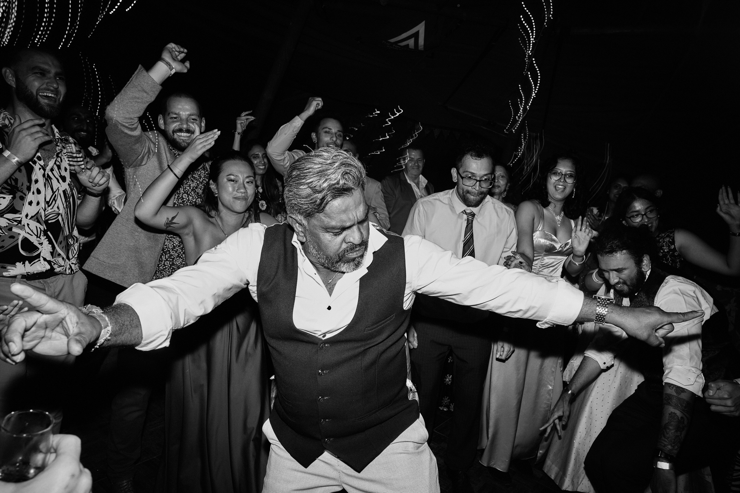 A guy busting a move on the dance floor at a party.