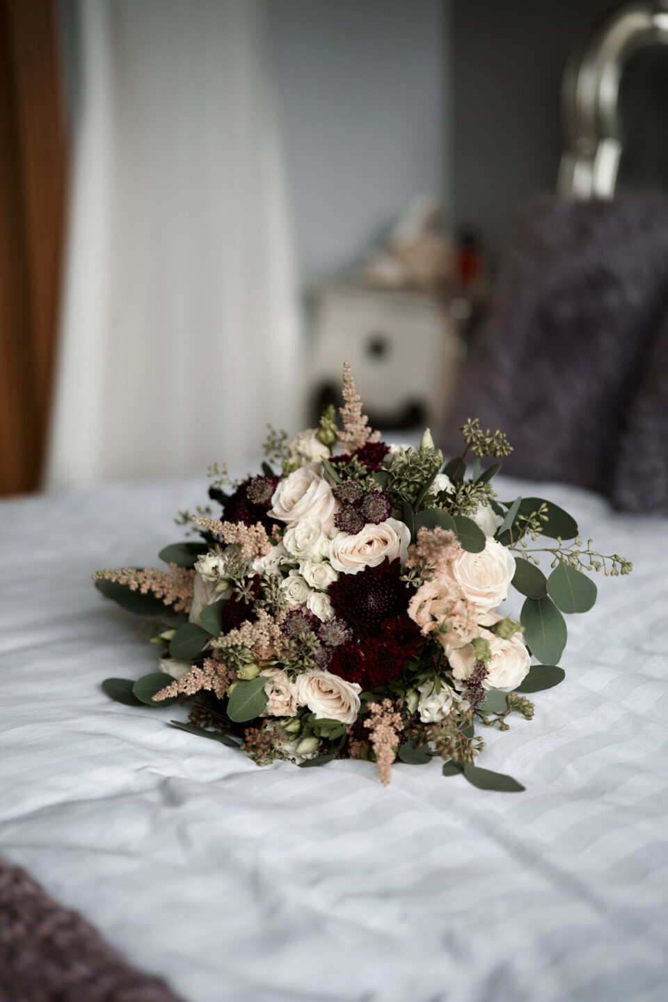 A bunch of flowers placed on a bed.