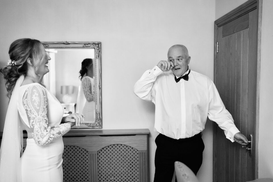A dad is watching his daughter prepare for her wedding.
