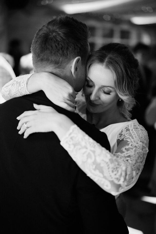 A man and woman embracing in their first dance as a married couple.