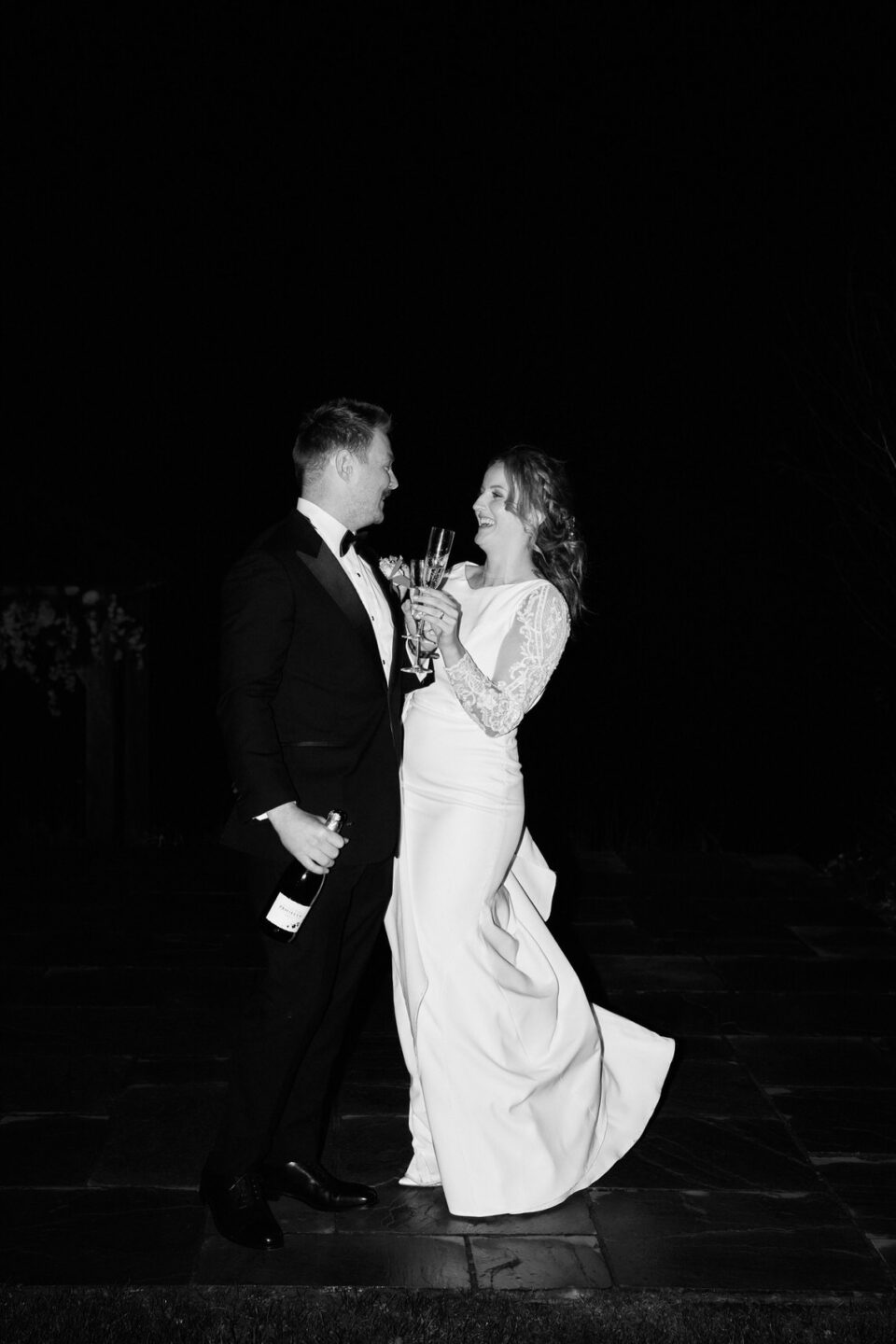 A nighttime picture of a bride and groom in black and white.