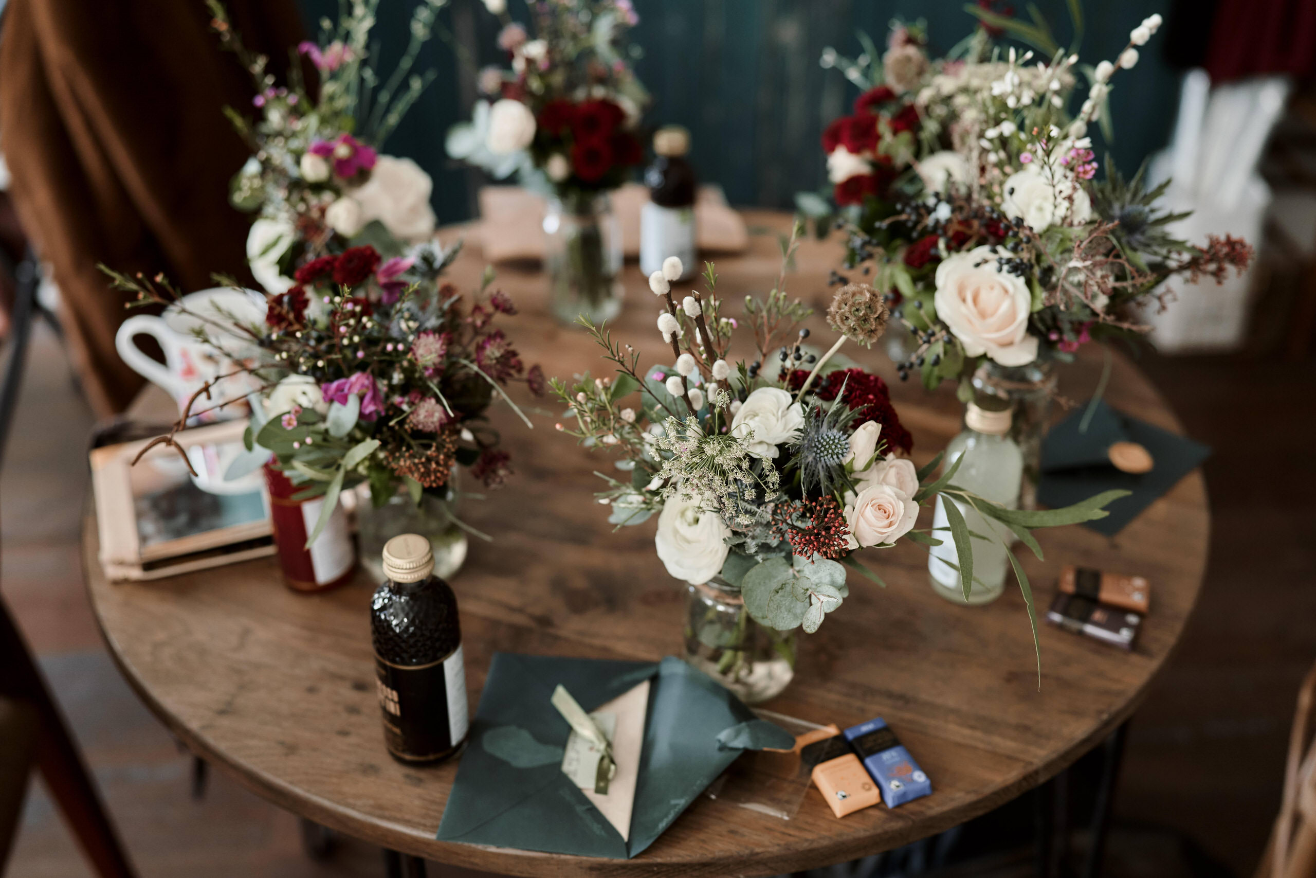 A table with flower vases on it.