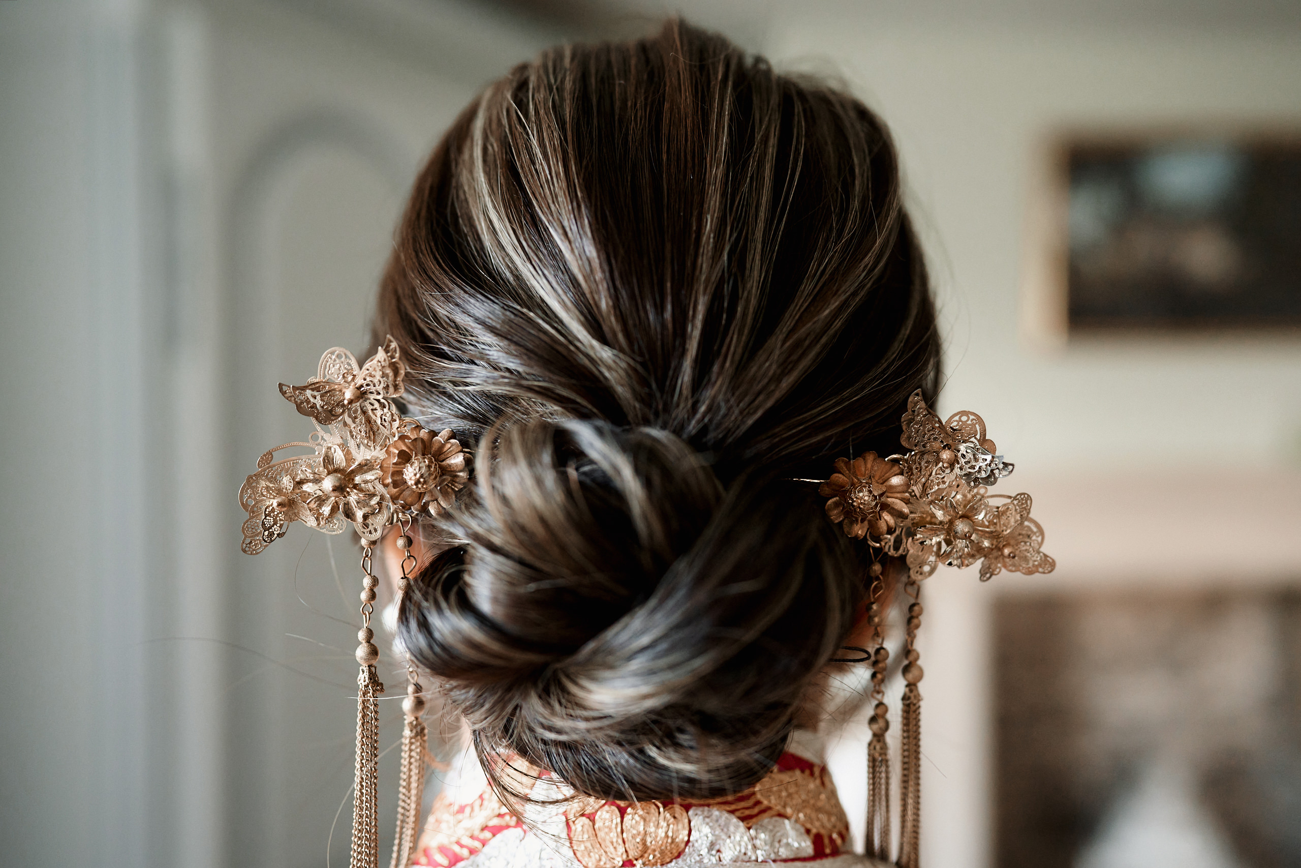 A woman's hair from behind, wearing an Asian accessory.