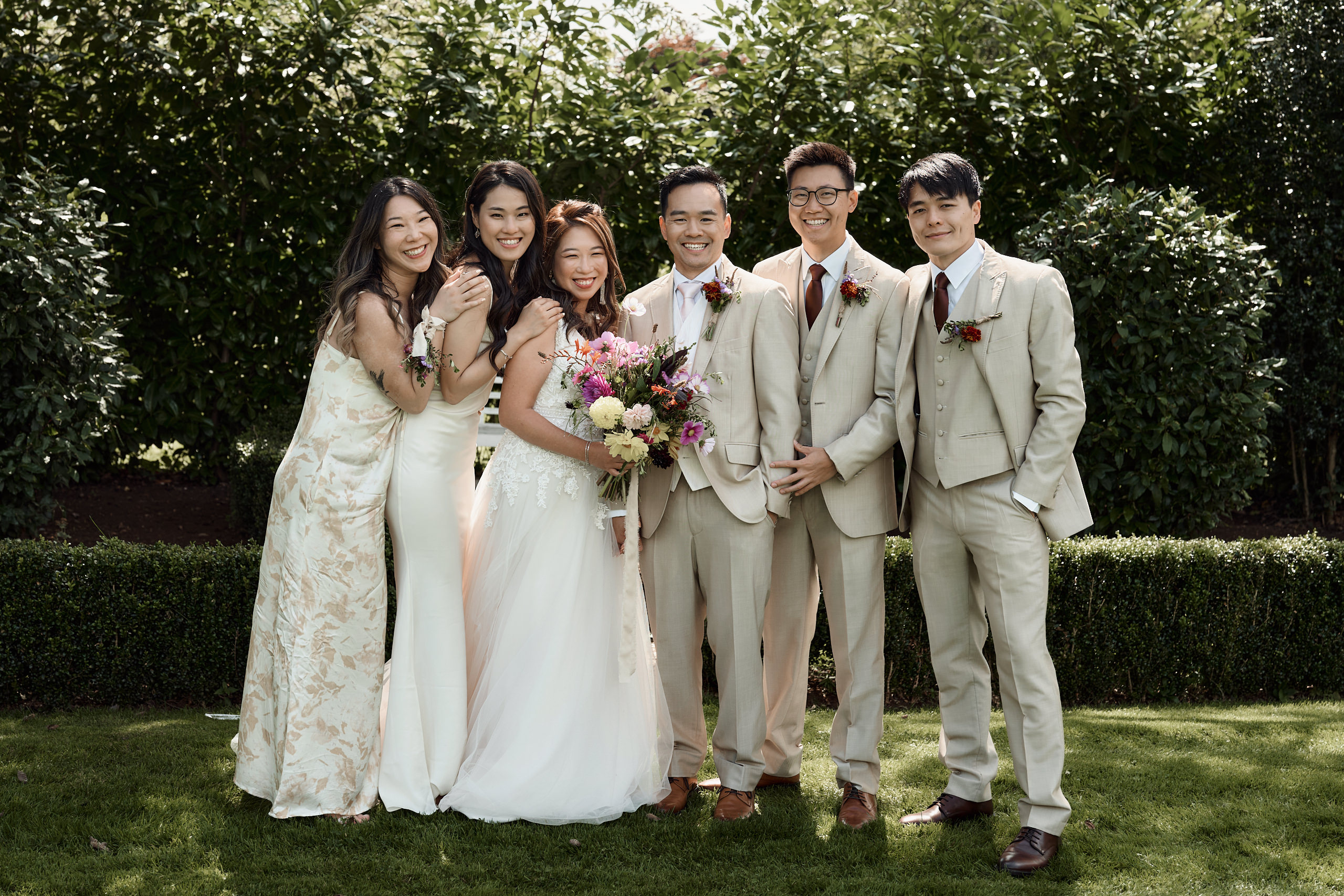 A bunch of Asian bridesmaids taking a picture.