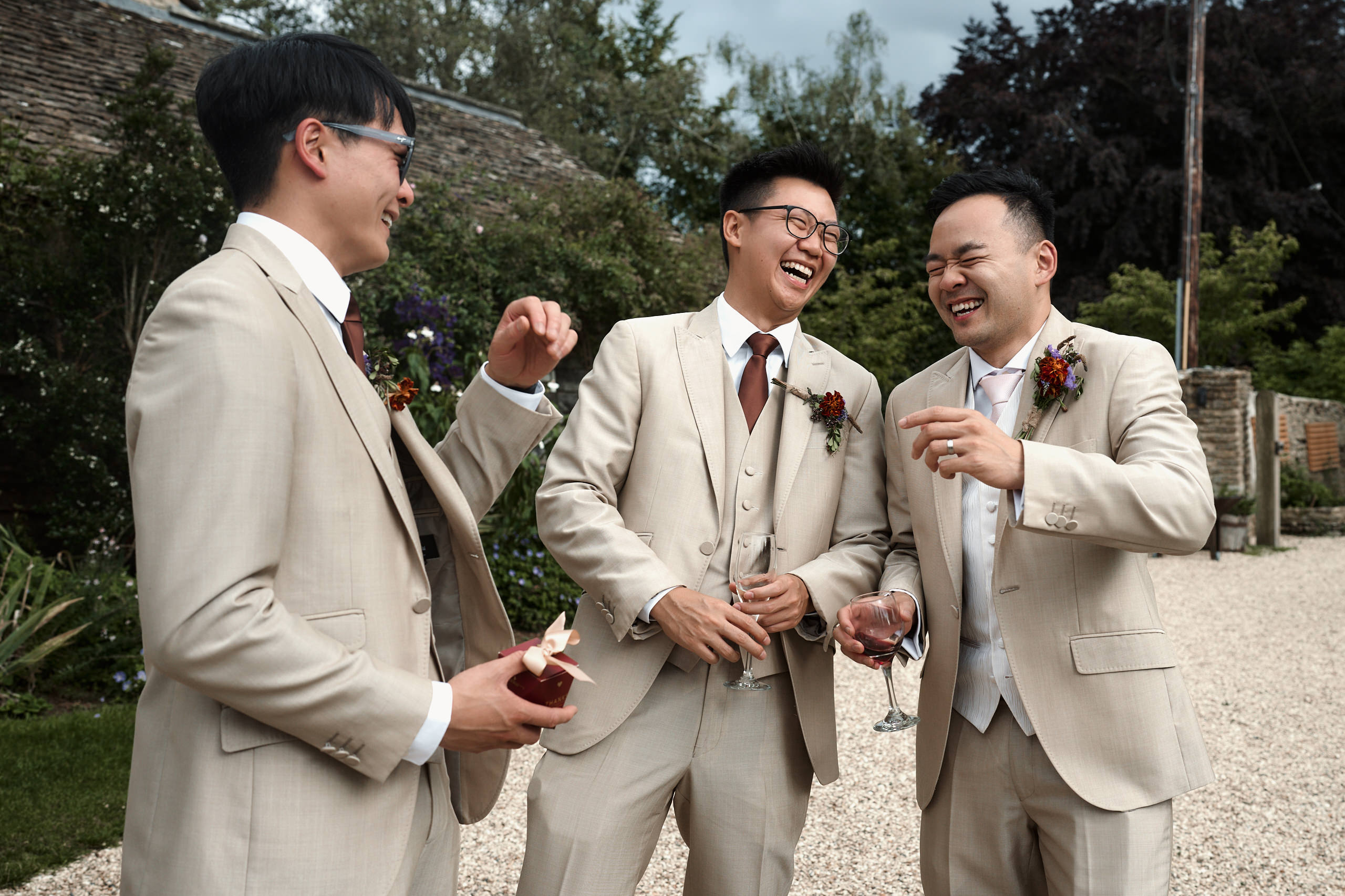 A bunch of guys in beige suits having a laugh.