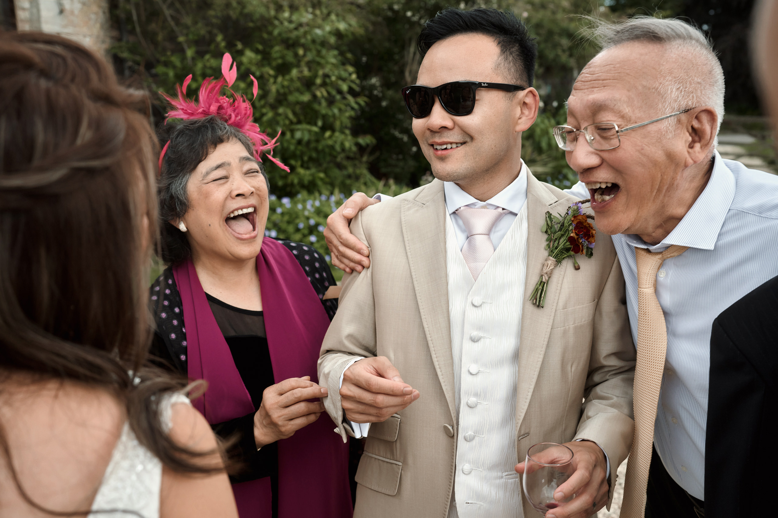 People cracking up at a wedding.
