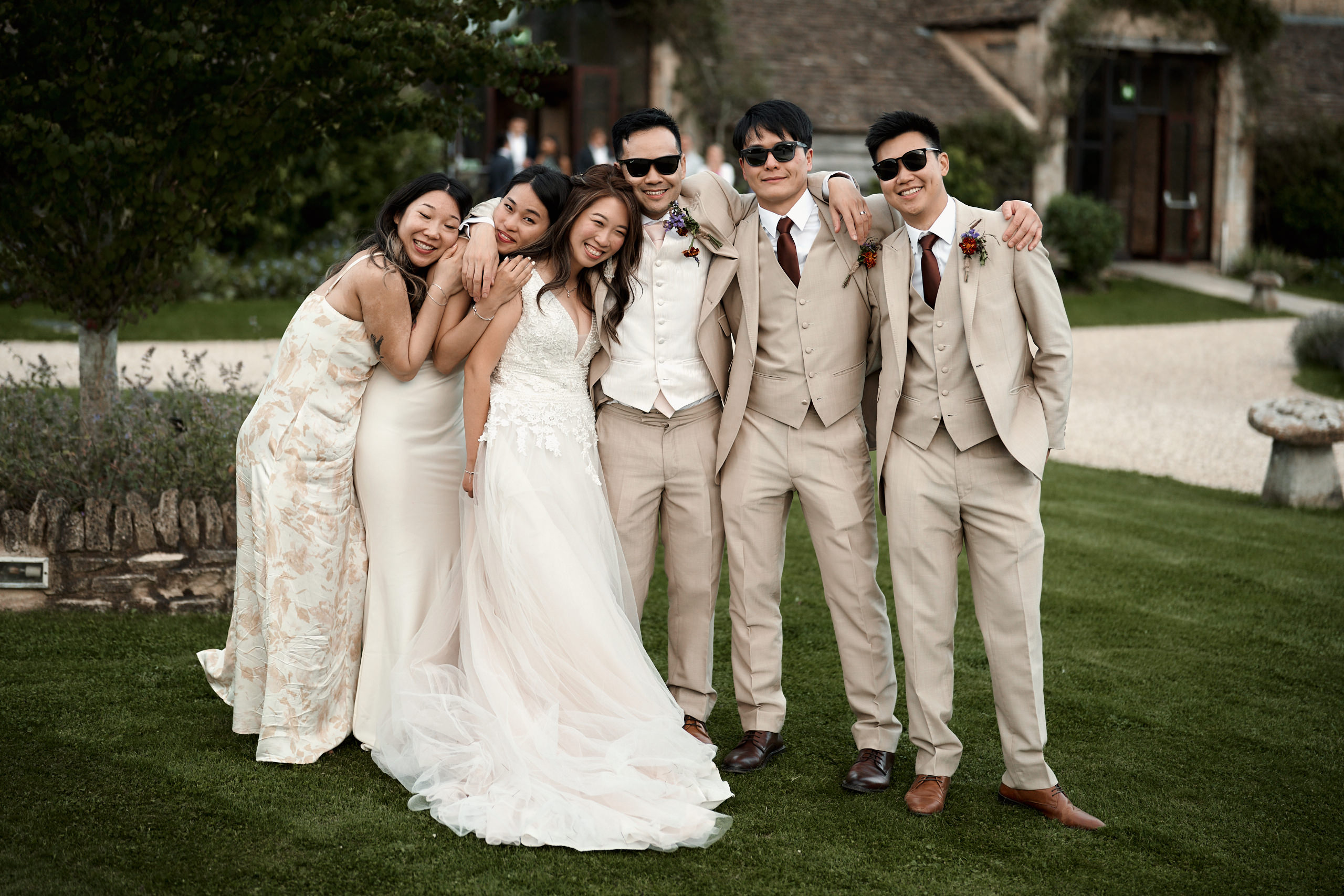 A bunch of people from an Asian wedding are taking a photo.