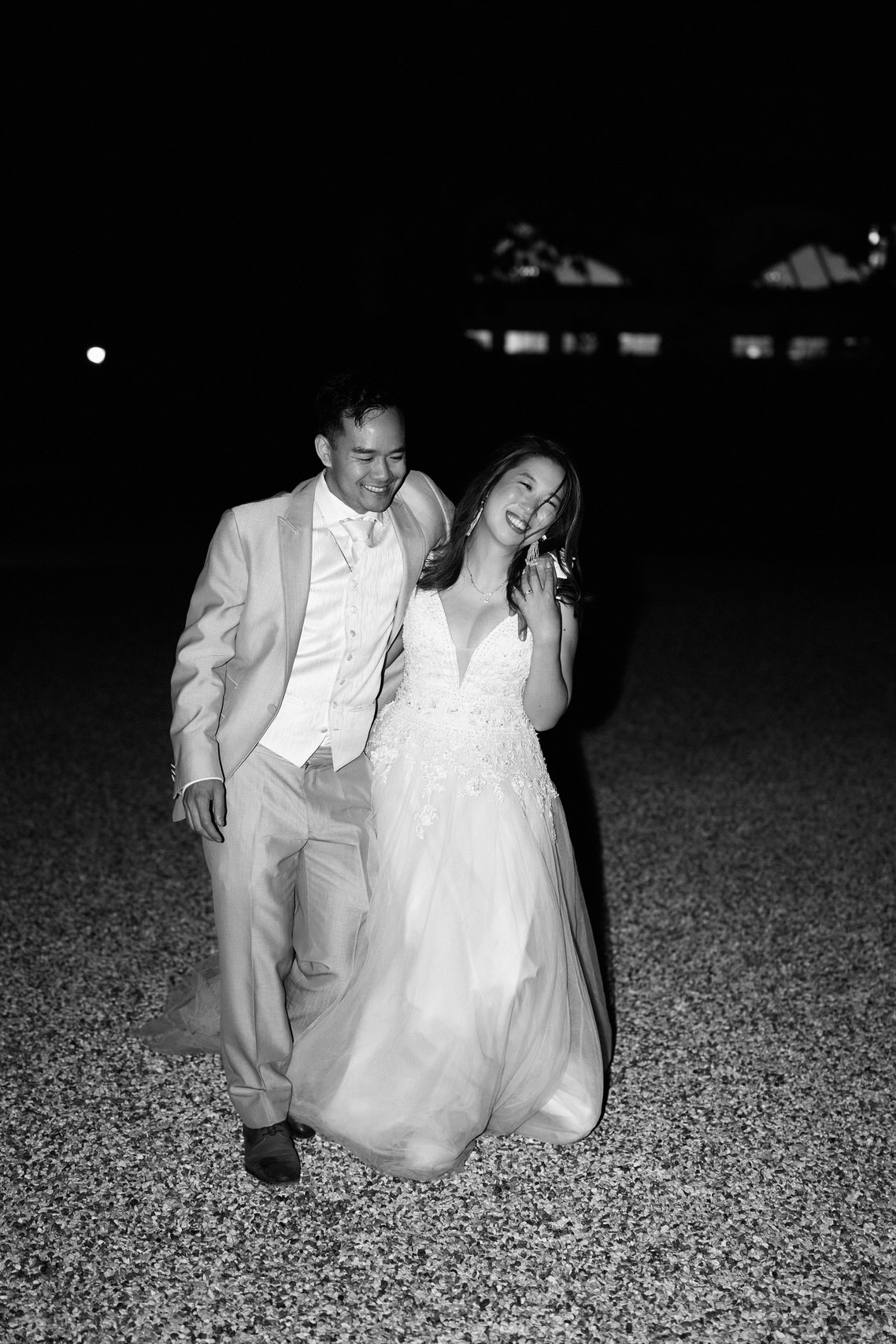 A nighttime photo of a bride and groom in black and white.