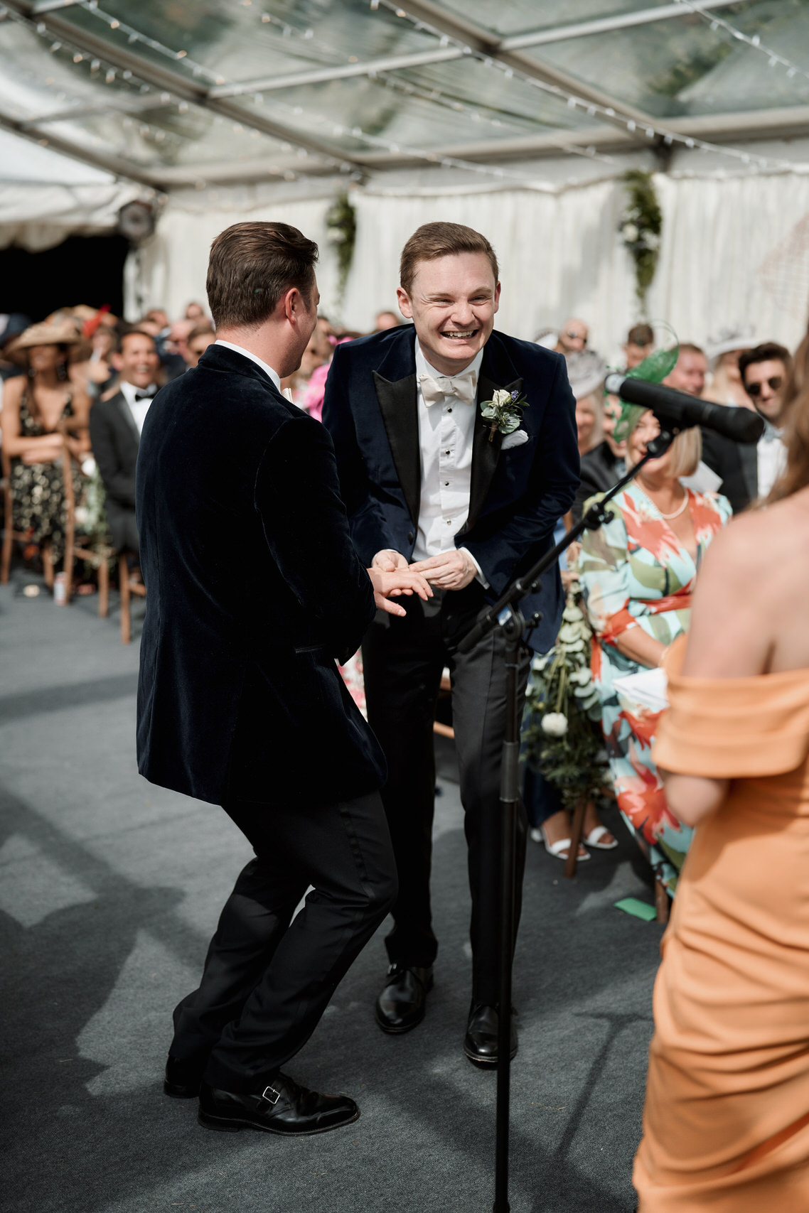 Two guys in tuxedos at a wedding.