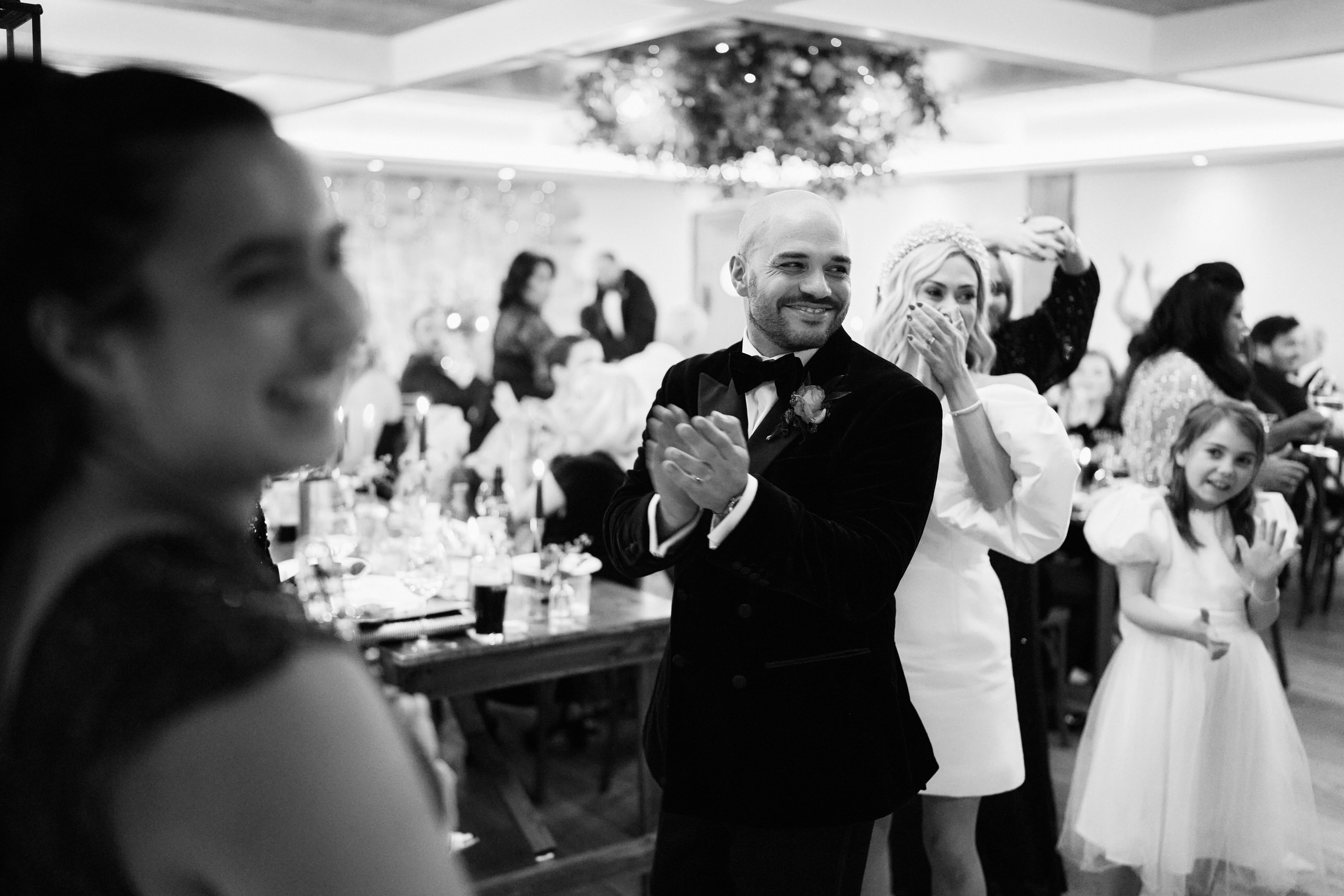 A guy applauding at a wedding party.