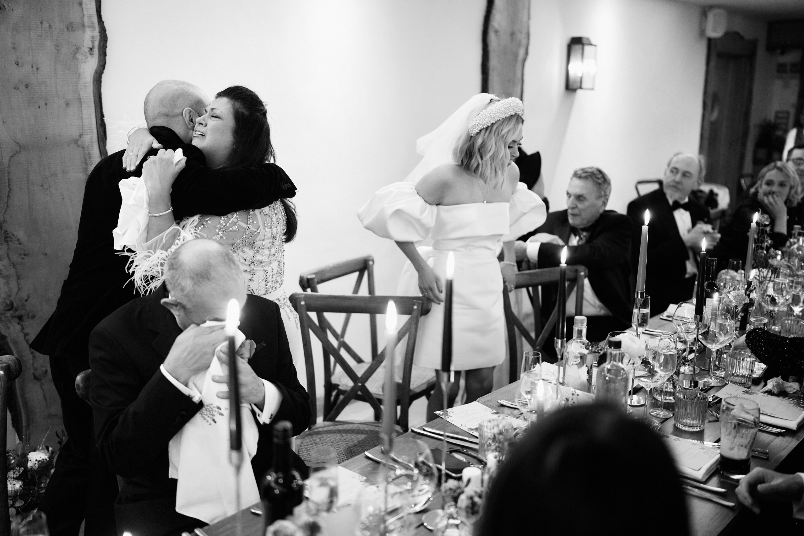 A man and woman kissing at their wedding party.