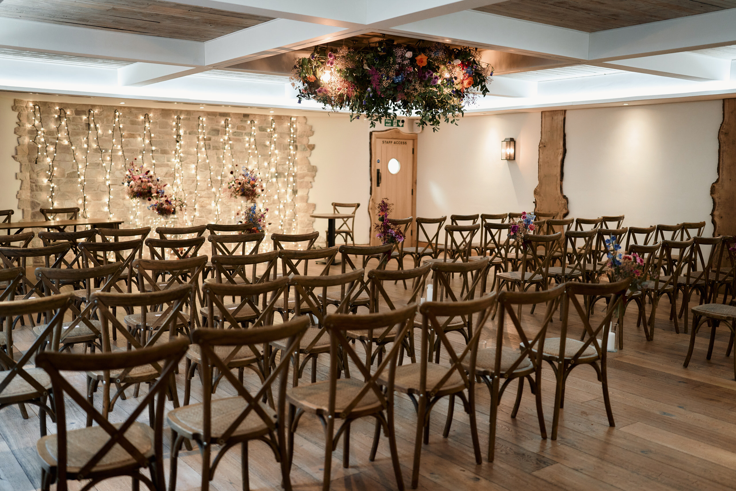 A room arranged with chairs for a wedding.